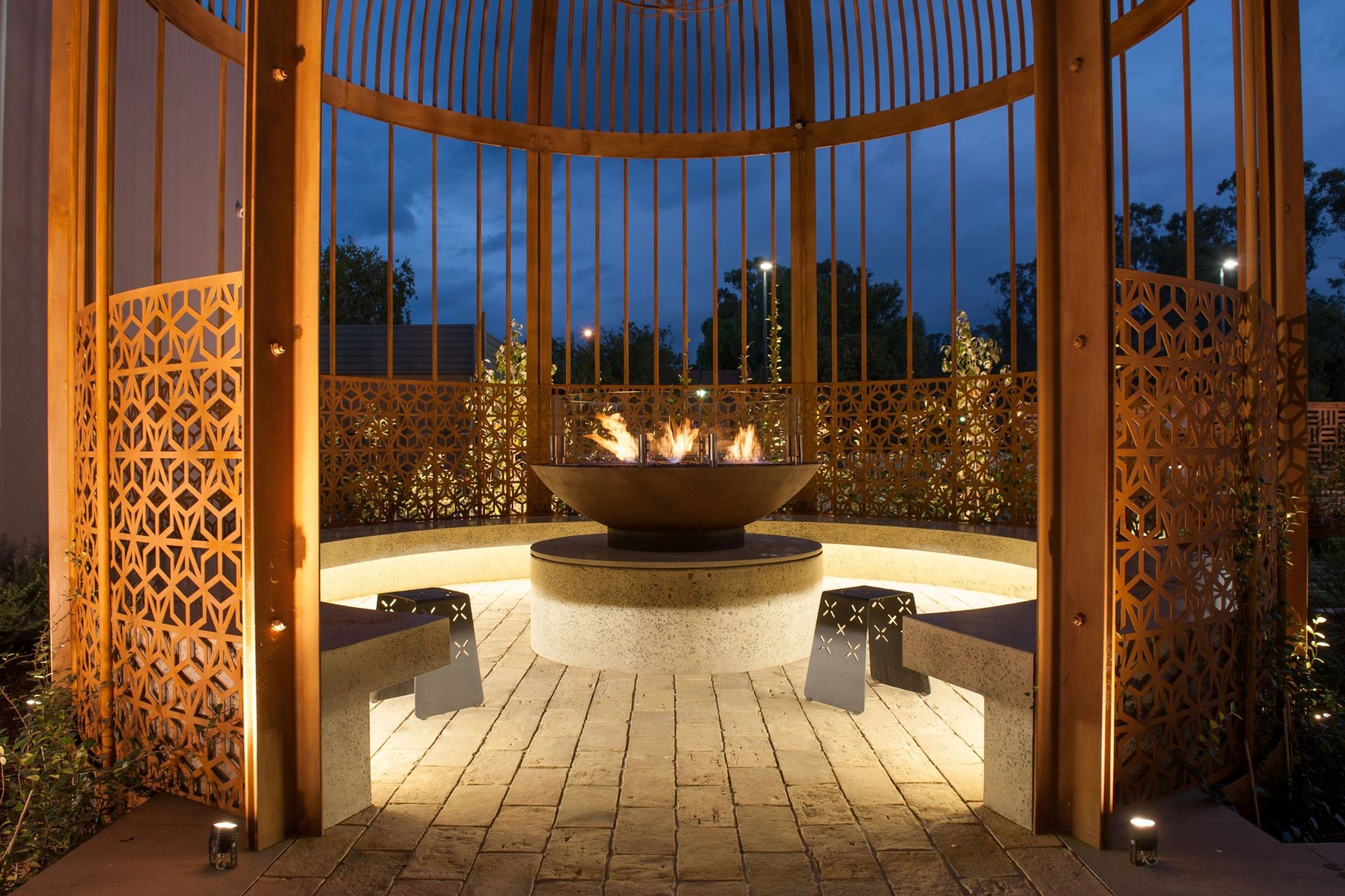 You can create a sanctuary within a sanctuary using a fire pit like the EcoSmart XL500 Ethanol Biofuel Fireplace and a garden shelter.