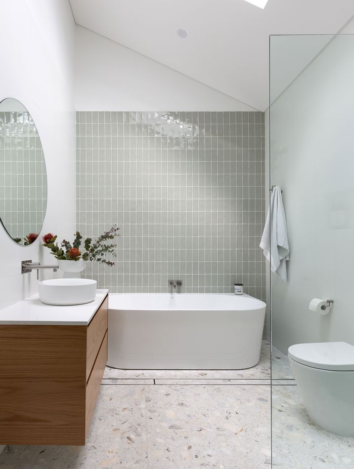 This bathroom by ViewThru Architects and Christina Prescott Design features a cathedral ceiling.