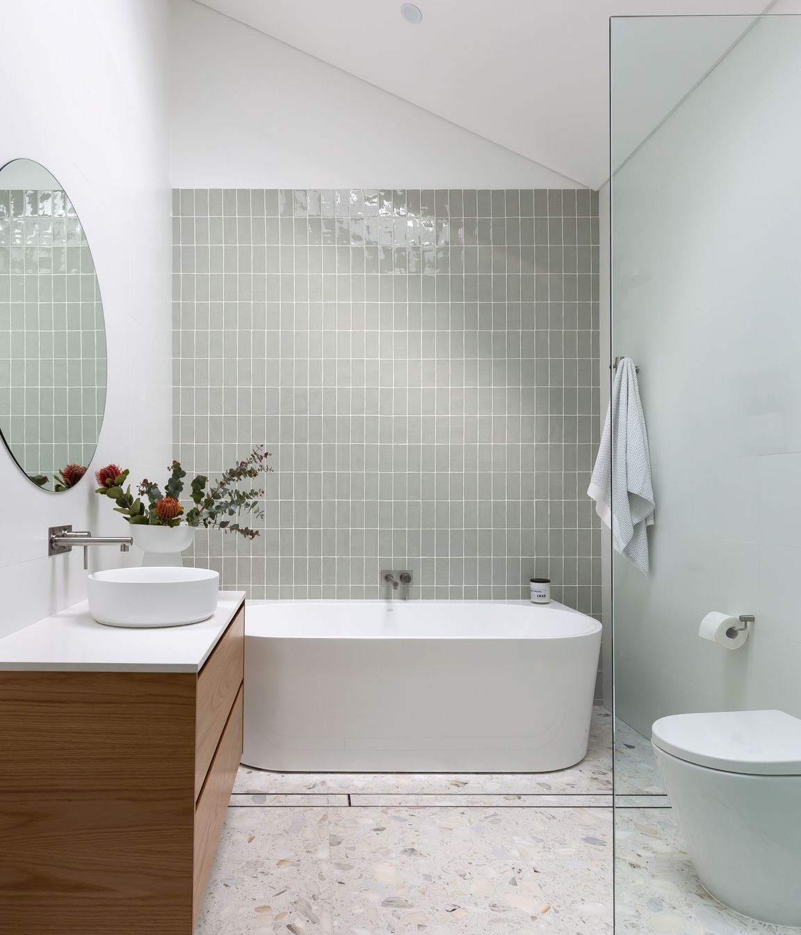 This bathroom by ViewThru Architects and Christina Prescott Design features a cathedral ceiling.