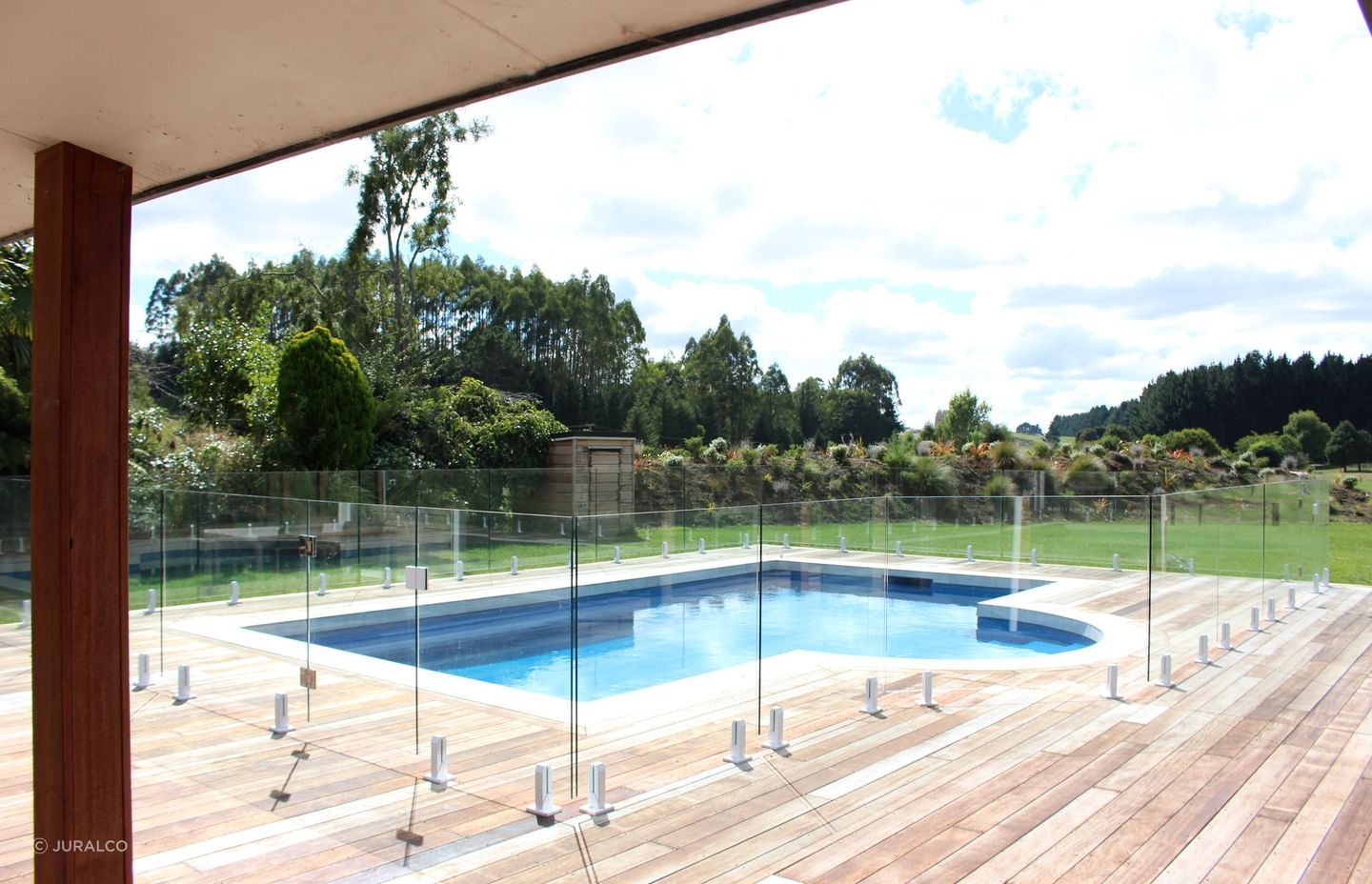 A designer inspired glass pool fence supported by Juralco's Edgetec® Balustrade Mini Post Clamps.