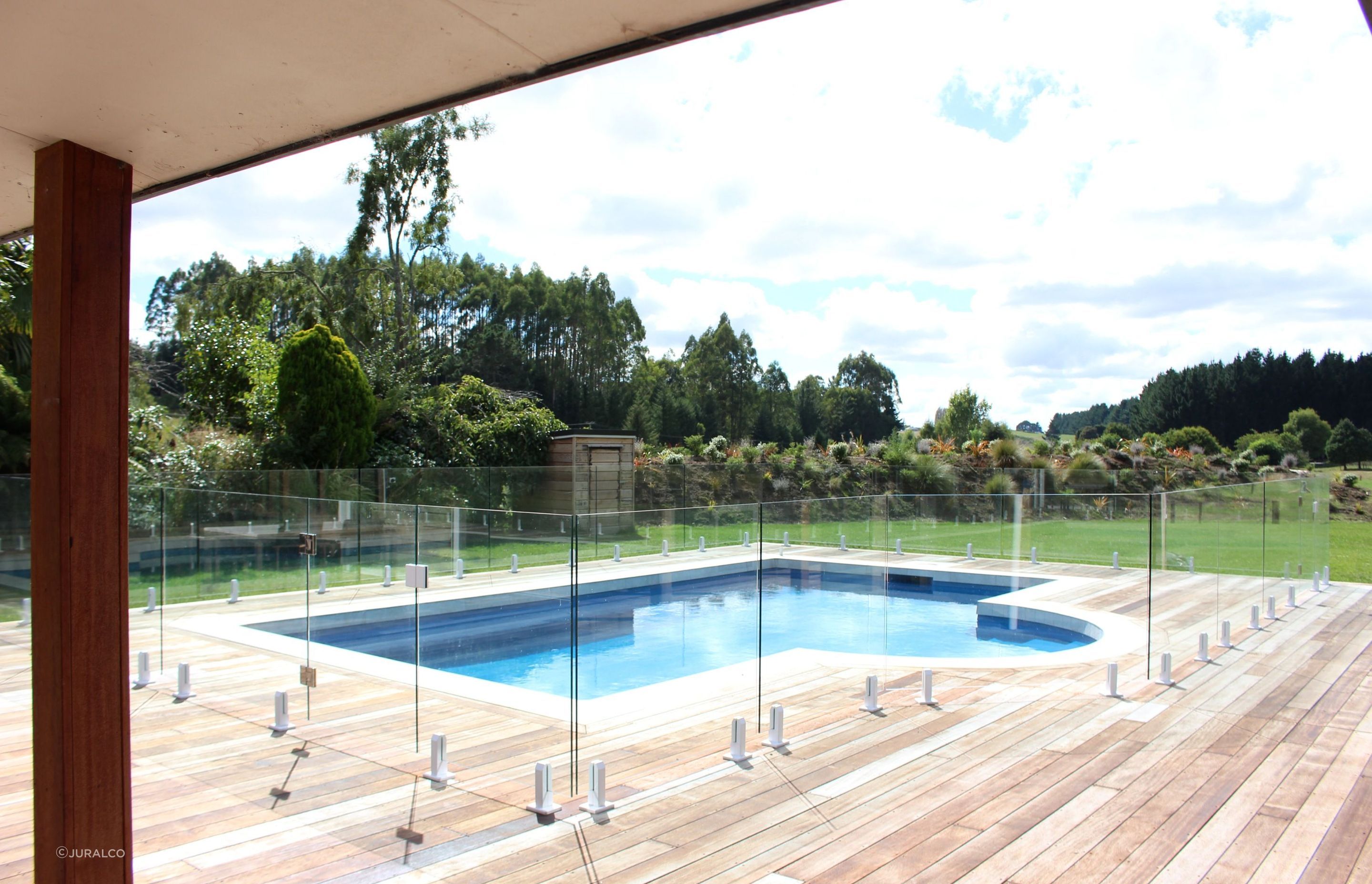 A designer inspired glass pool fence supported by Juralco's Edgetec® Balustrade Mini Post Clamps.