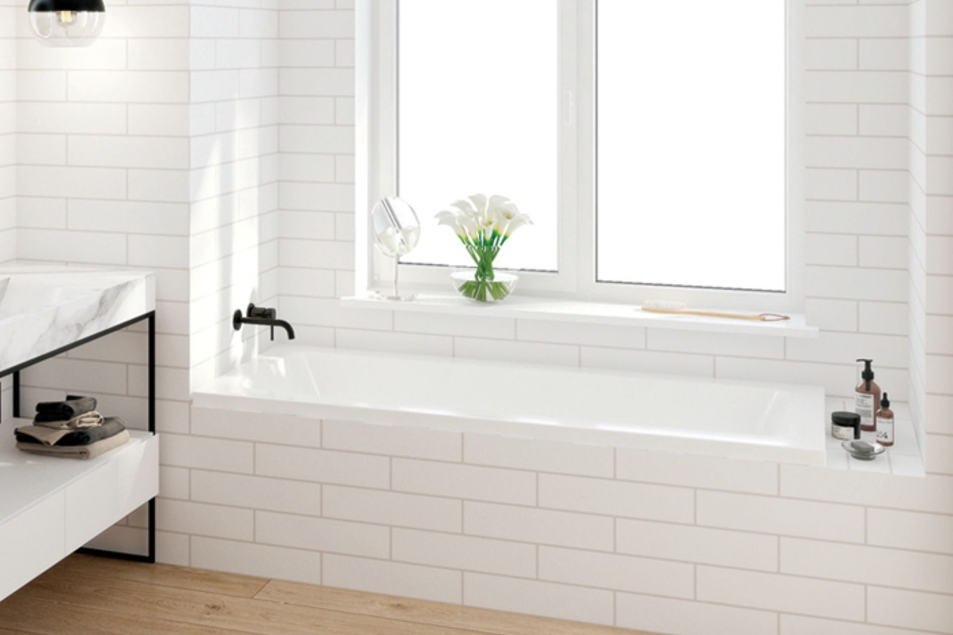 A sleek drop-in bath from the Elementi Collection by Robertson Bathware, neatly installed in an alcove space.