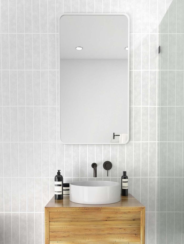 A rectangular bathroom mirror enhances a bathroom with its simplistic yet timeless charm. Featured product: Radius Rectangle Mirror.