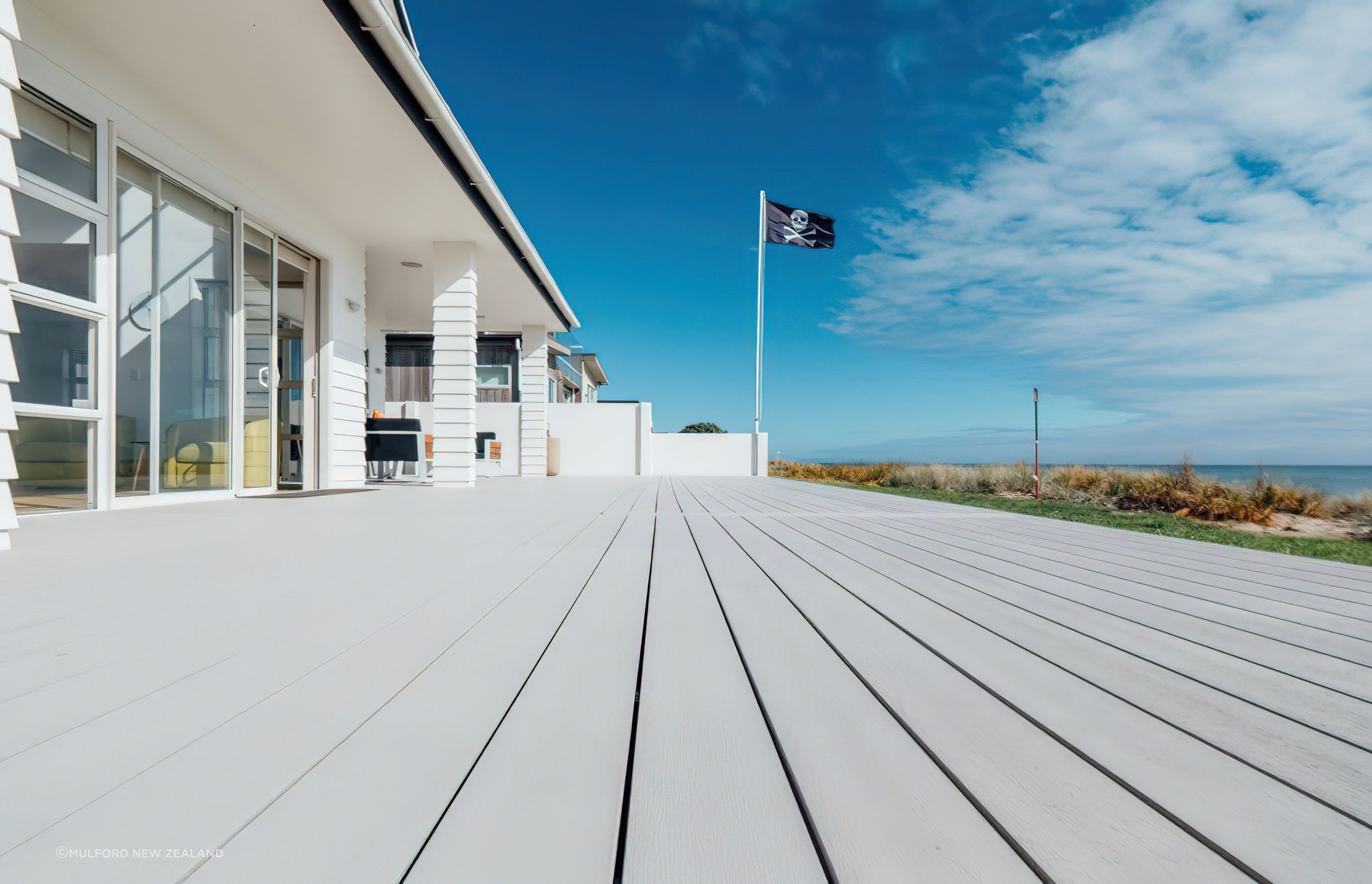 This composite decking solution from Futurewood Decking provided the homeowners with a stylish and low-maintenance deck for this sunny coastal location.