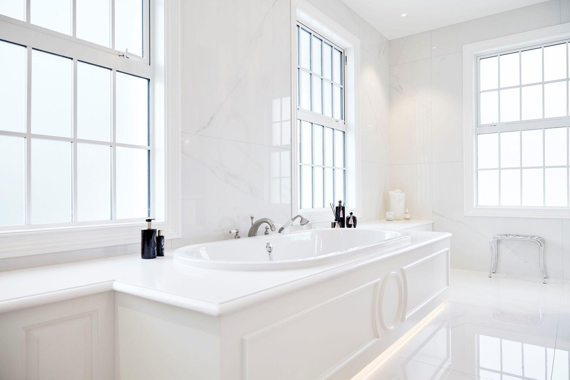 One of the most luxurious bathrooms featured, thanks to the refined use of white natural stone tiling.