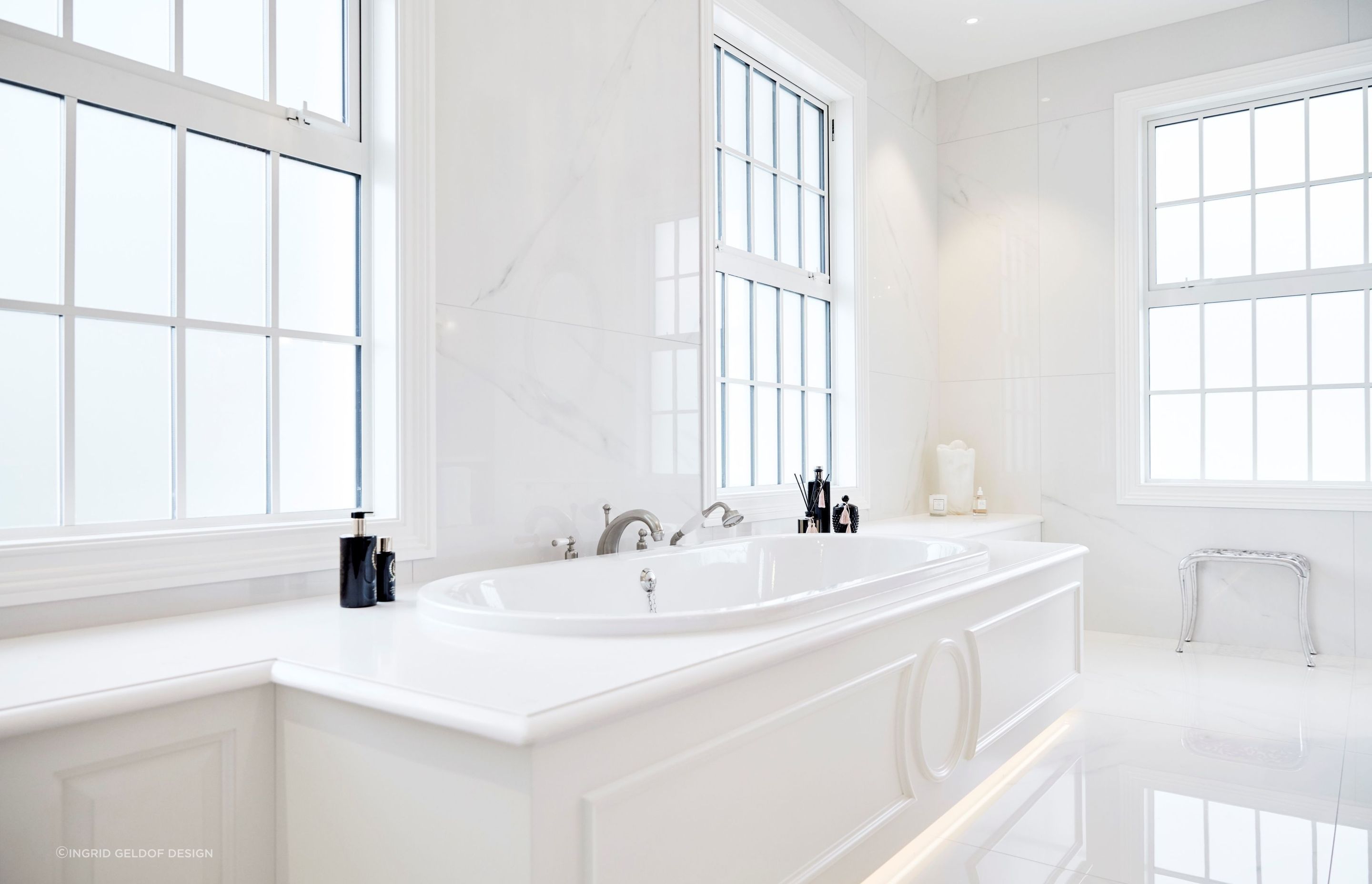 One of the most luxurious bathrooms featured, thanks to the refined use of white natural stone tiling.