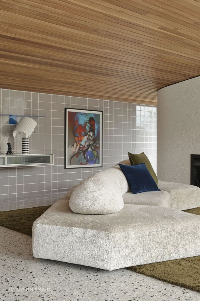 Soft organic furniture forms are balanced against timber, terazzo and tiles.