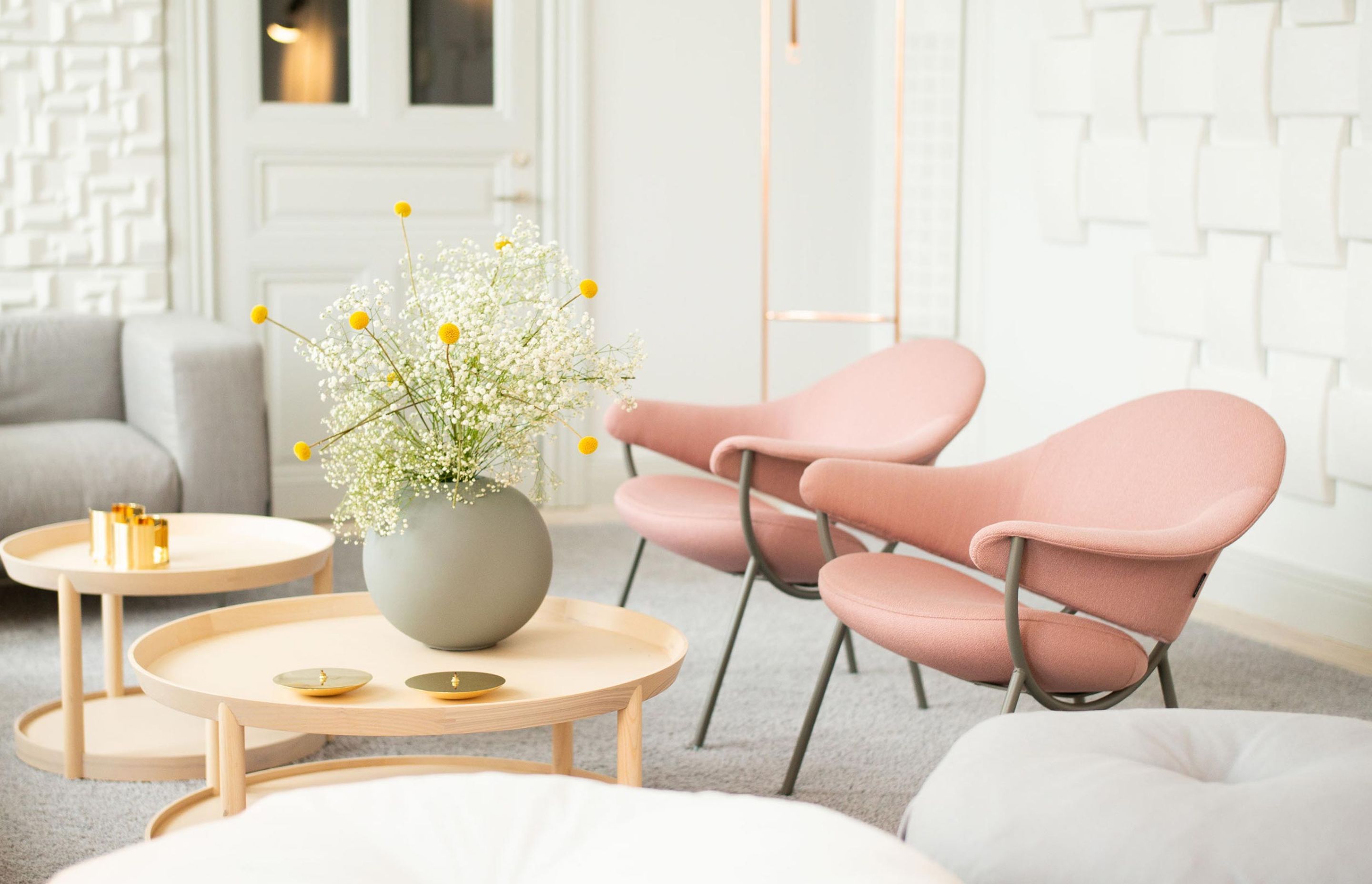 A lounge setting, featuring an array of Offecct furniture, including Murano chairs by Luca Nichetto, and Soundwave® Wicker, Acoustic panel by Wingårdh and Wikerstål