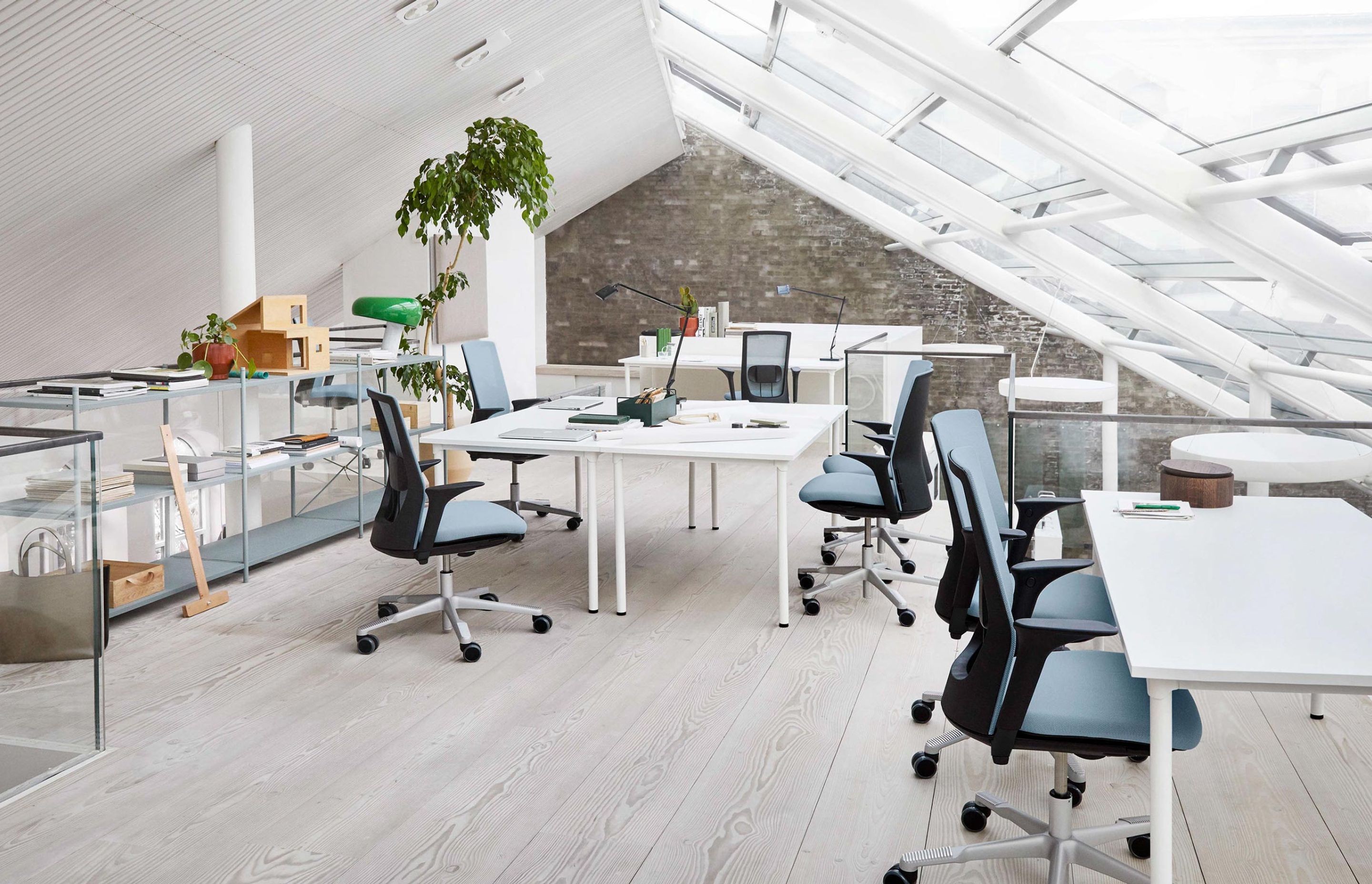 An attic office space with big ceiling windows, featuring HÅG Futu