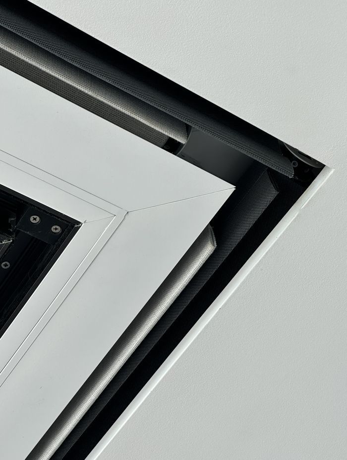 Recessed Flushboxes are integrated into the ceiling, creating a perfectly seamless space.