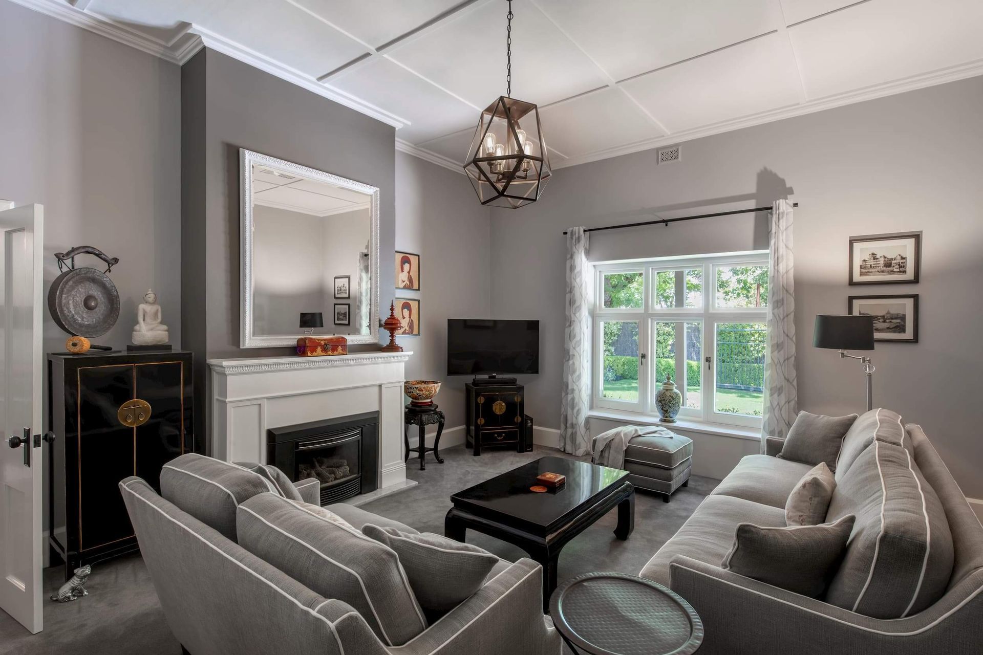 The neutral hue of the sofas fit well in this stylish grey living room exude a sense of calm and sophistication. Featured project: Weybridge House.