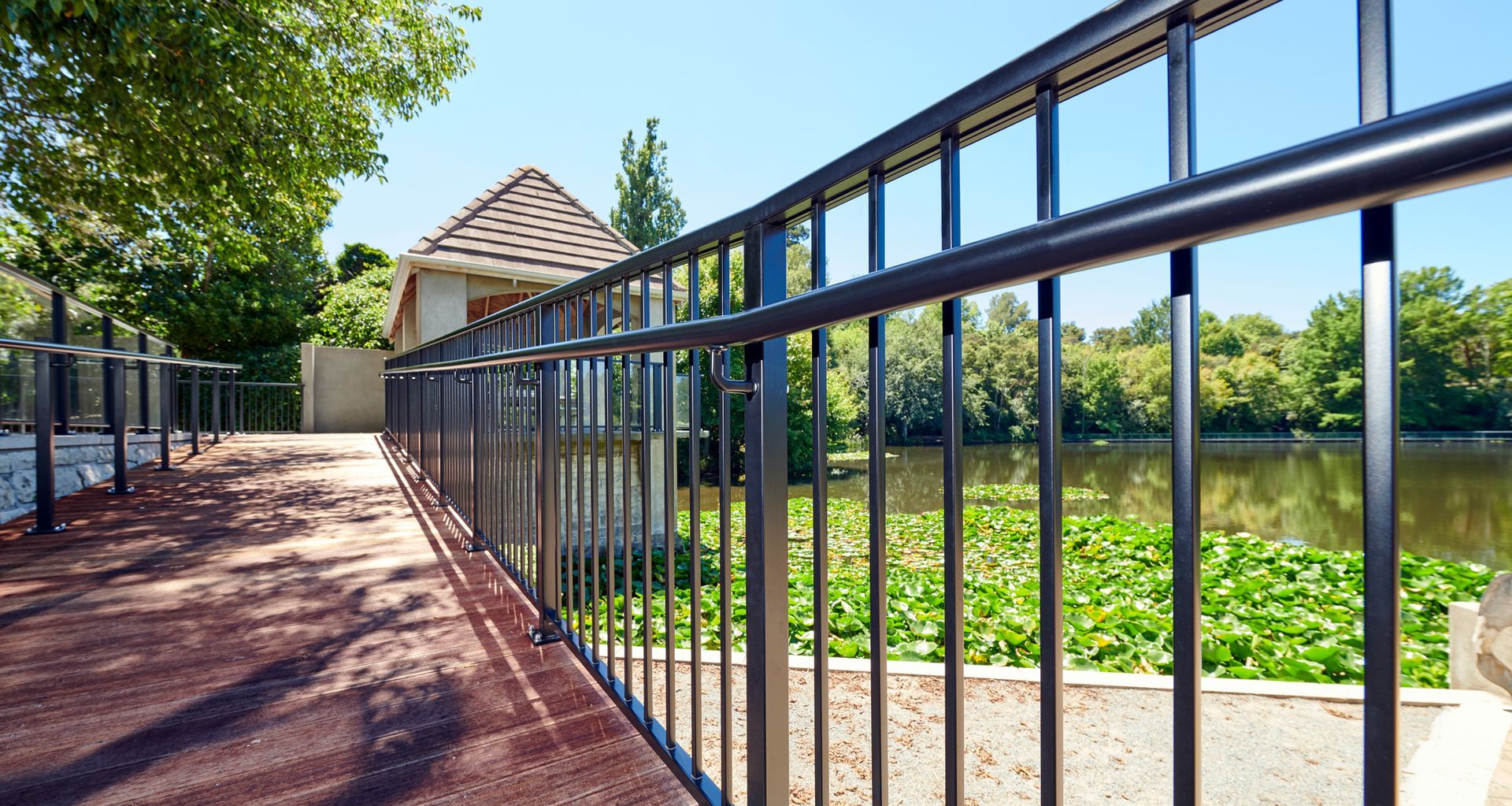This image and below: These images showcase UNEX balustrades at Hamilton Gardens, featuring the X1500 Balustrade in glass and aluminium with a handrail. These balustrades offer a durable and visually appealing solution for enhancing safety in a high-traffic public space.