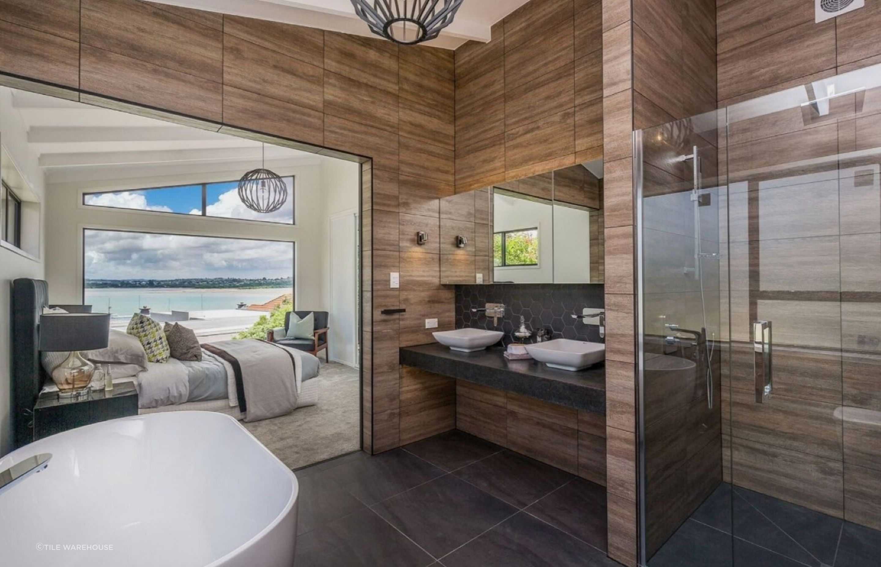 The large format Heartwood Floor Tiles help increase the sense of space in this stylish ensuite.