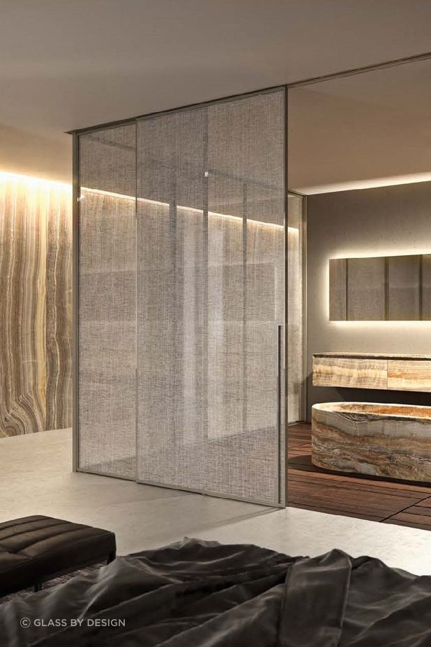 Fabrics, like pleated linen or mesh, can be inserted into the middle of the glass panels to match curtains or other furnishings in the room.