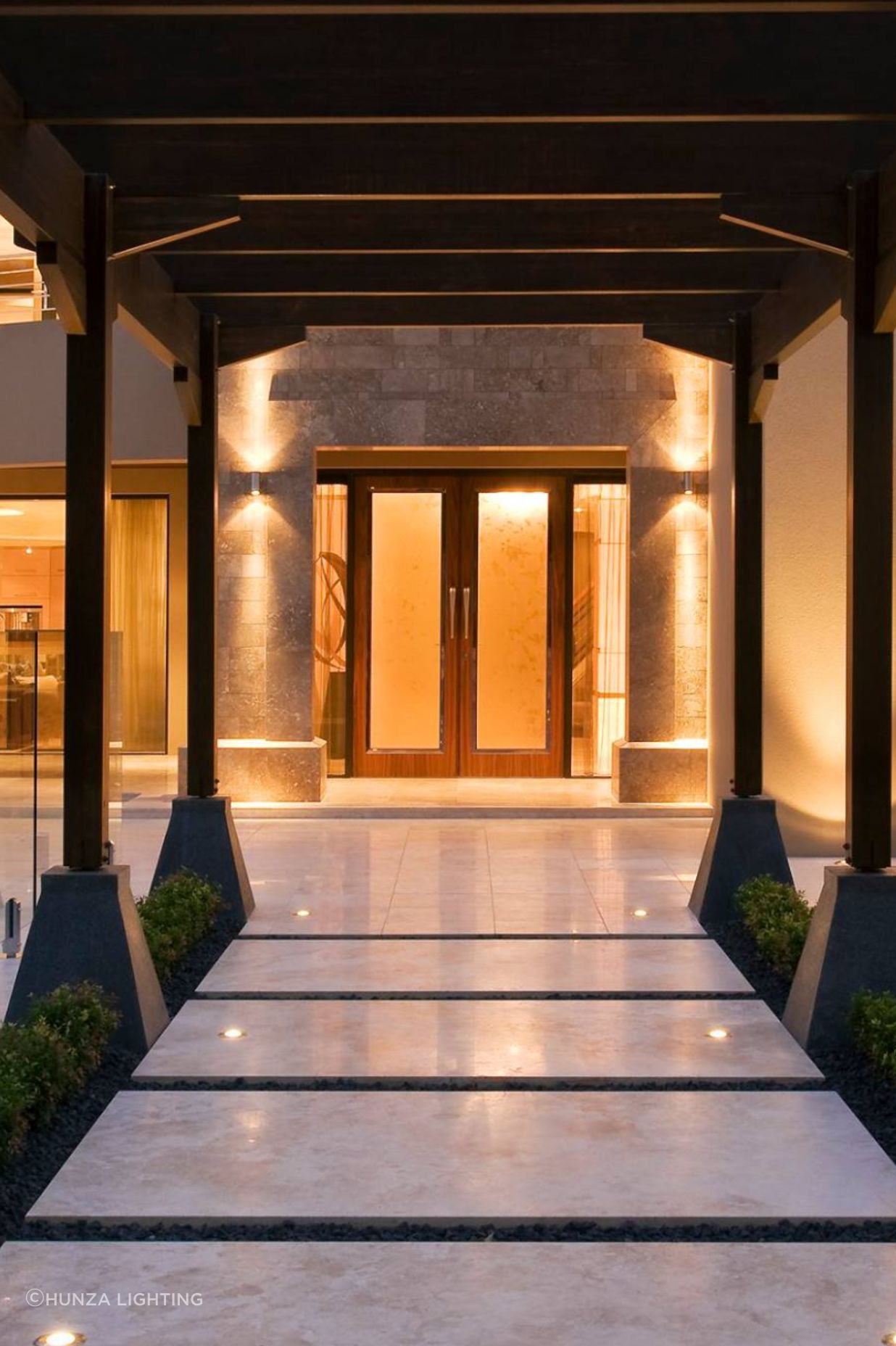 Outdoor pillar lights keep the entrance to this house well lit, while the walkway lights highlight the garden beds.