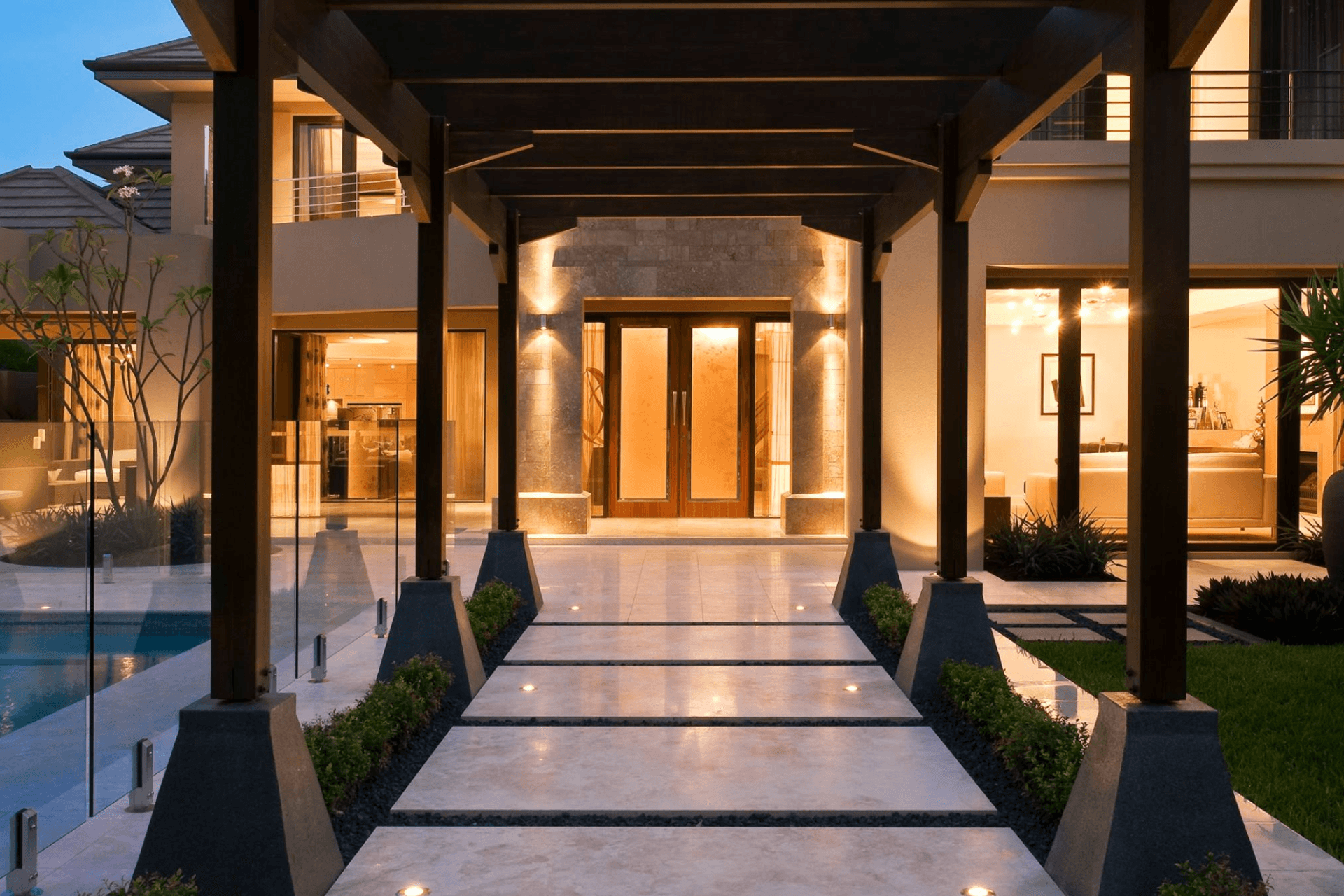 Outdoor pillar lights keep the entrance to this house well lit, while the walkway lights highlight the garden beds.
