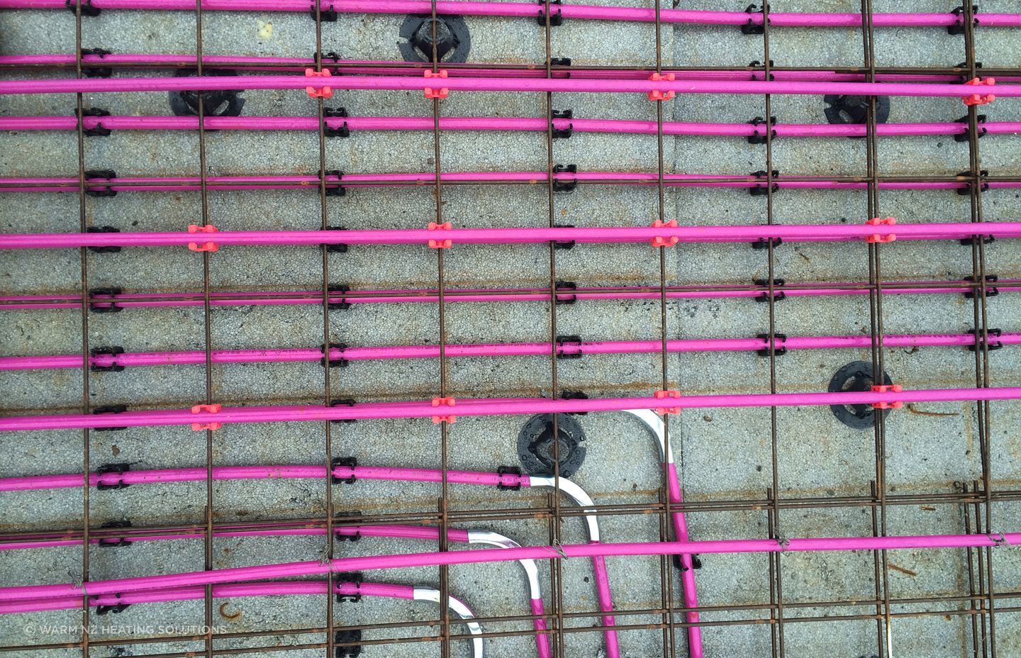 The underfloor systems are all custom-designed by qualified heating engineers. Instead of using radiators to heat a room, hot water pipes are laid either into the concrete floor slab or under wooden floors between the joists. This warms the slab/floor, providing a warm floor and radiant heat in the room.