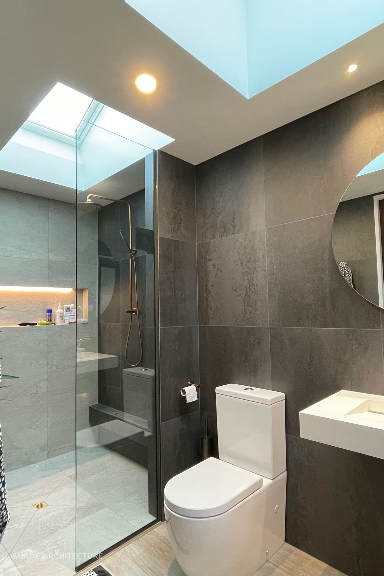 Recessed tiled shower shelves offer storage in a modern way while not encumbering the space.