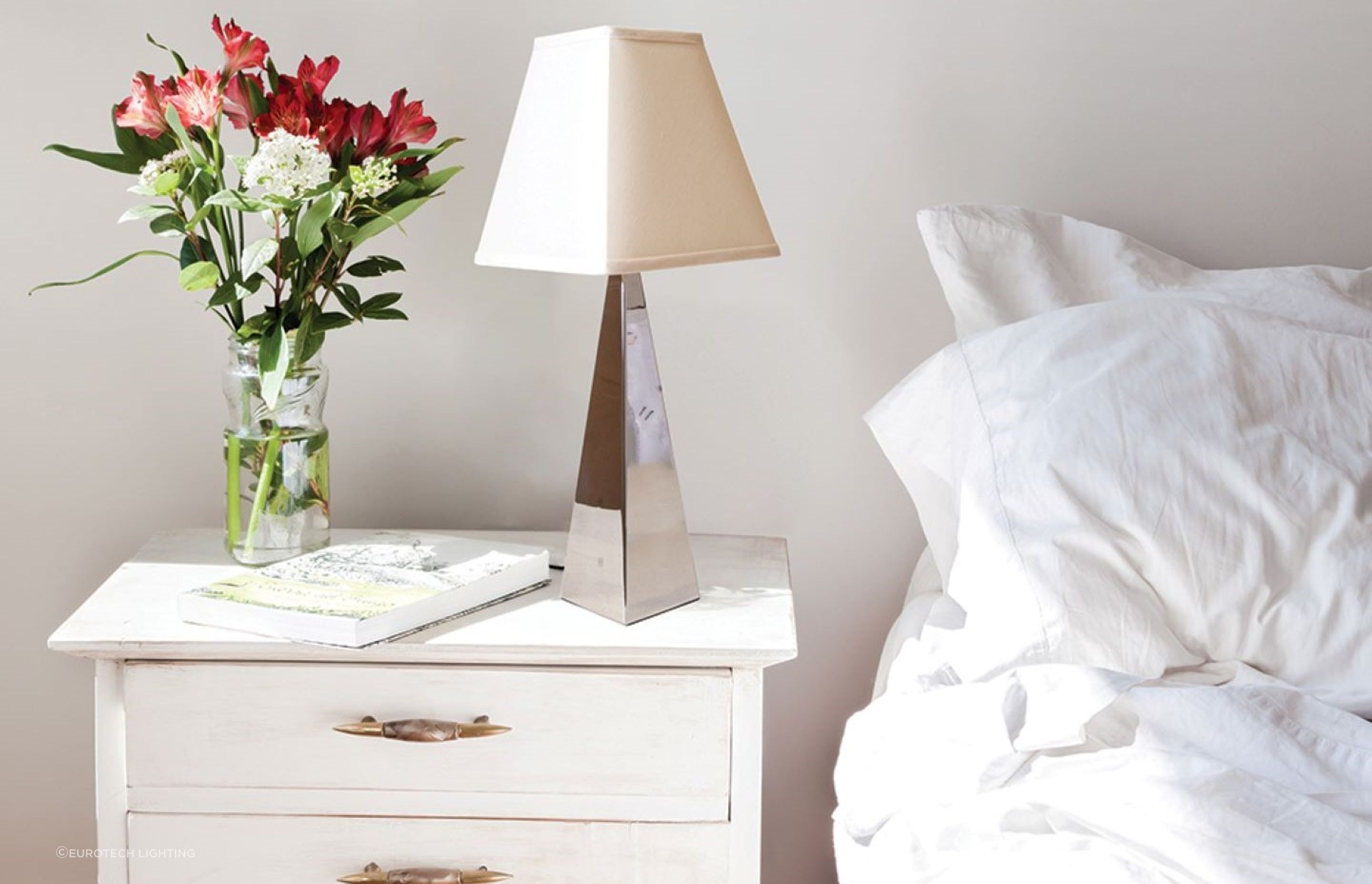 A bedside table provides a great opportunity for an exquisite table lamp to shine, seen here with the Indie Table Lamp.