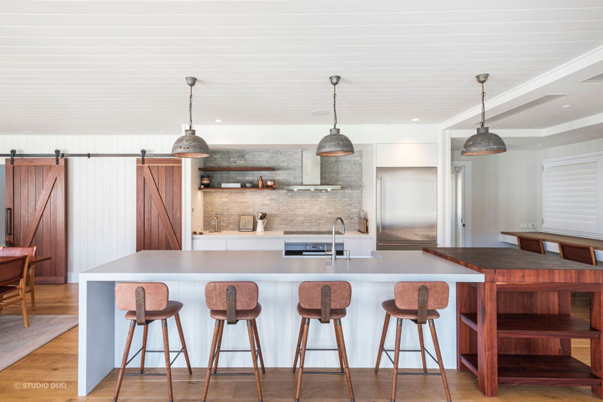 Industrial or farmhouse pendant lights add a rustic appeal to a kitchen.