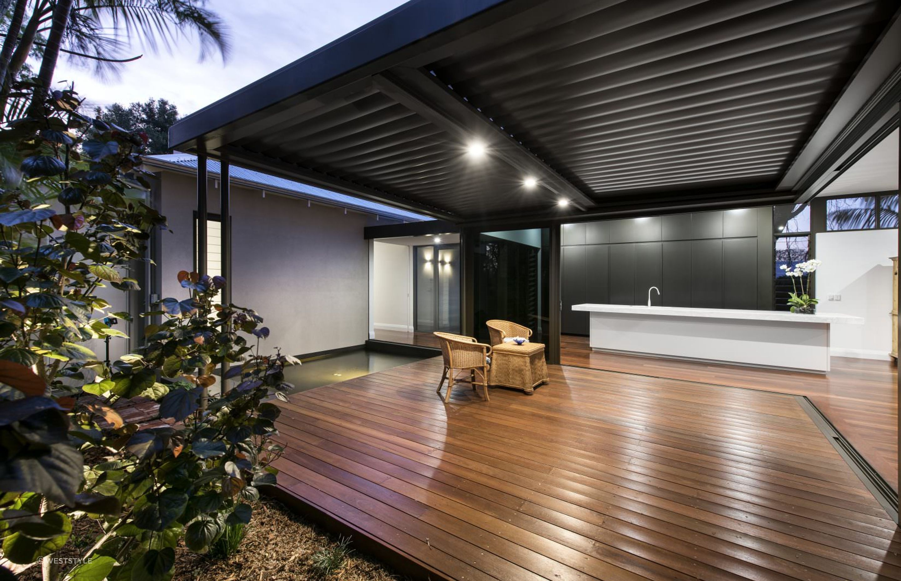 Jarrah decking highlights its deep reddish-brown tones, offering durability and a distinct charm to outdoor areas