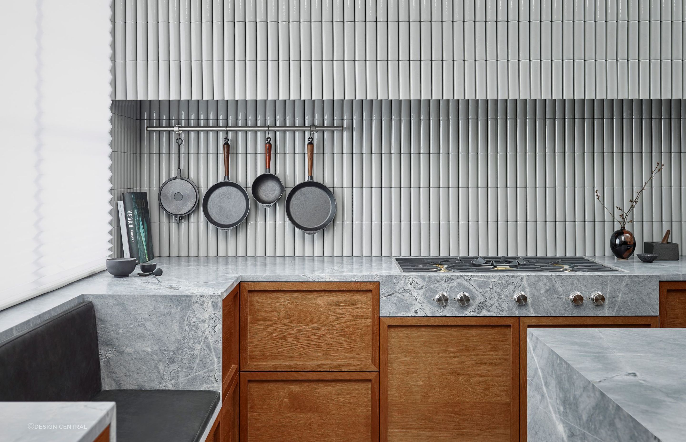 Continuity is key when working in kitchens with multiple walls and surfaces as seen in this beautifully tiled kitchen featuring the Soap Tiles by Sebastian Herkner for Kaufmann Keramik.