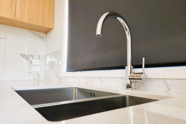 Classic materials and shapes befit this new villa kitchen by SAS Builders.