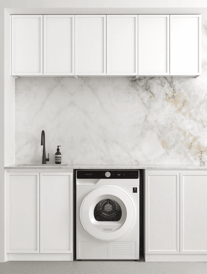 Ample counter space complimented with utility sink for this laundry room