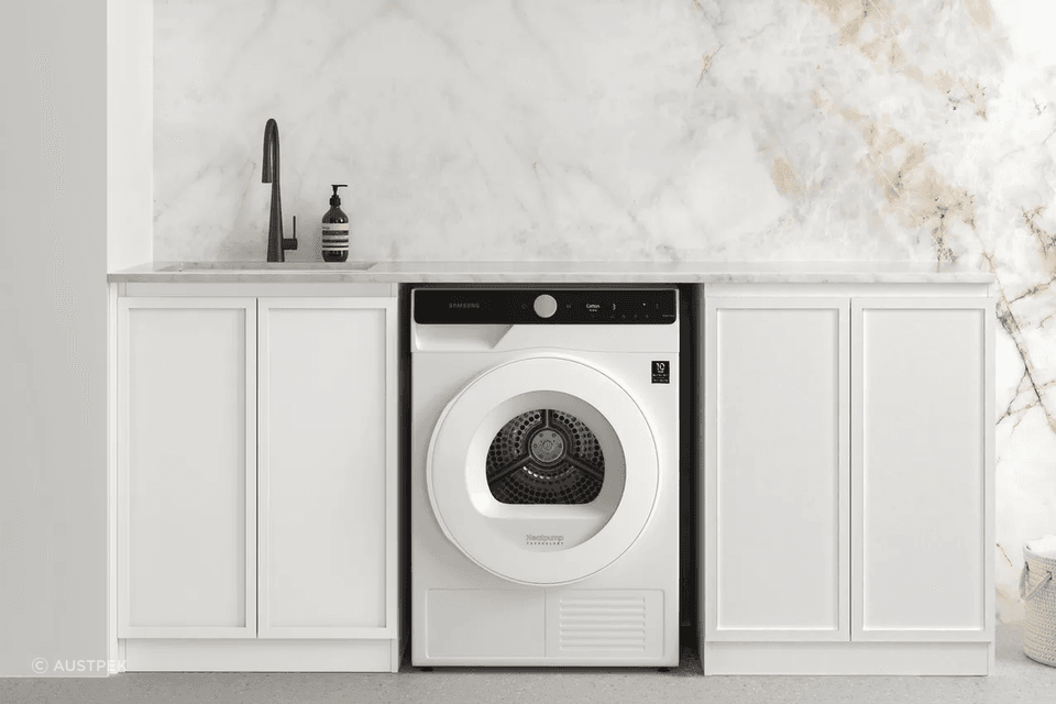 Ample counter space complimented with utility sink for this laundry room