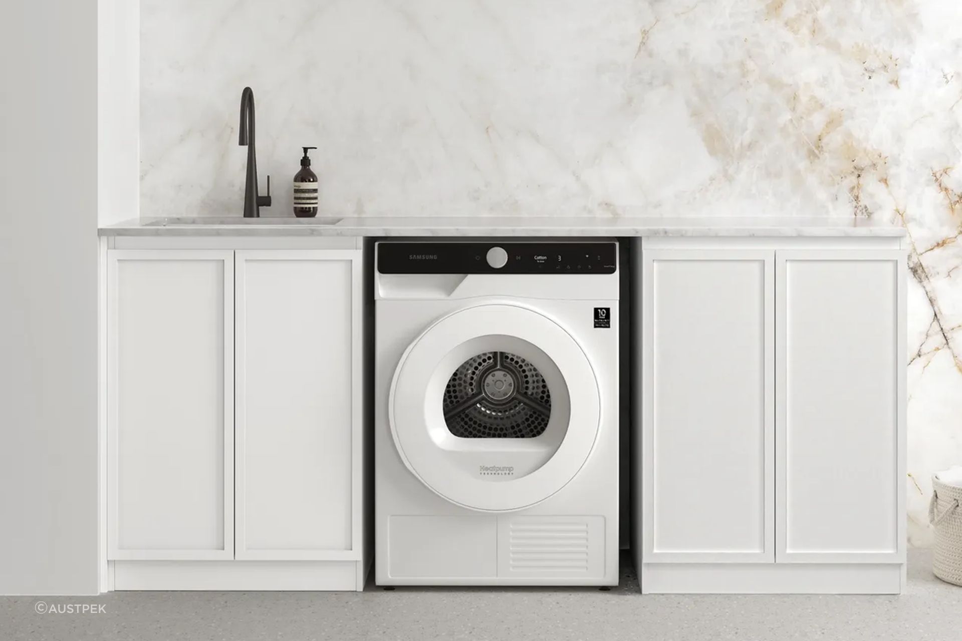Ample counter space complimented with utility sink for this laundry room
