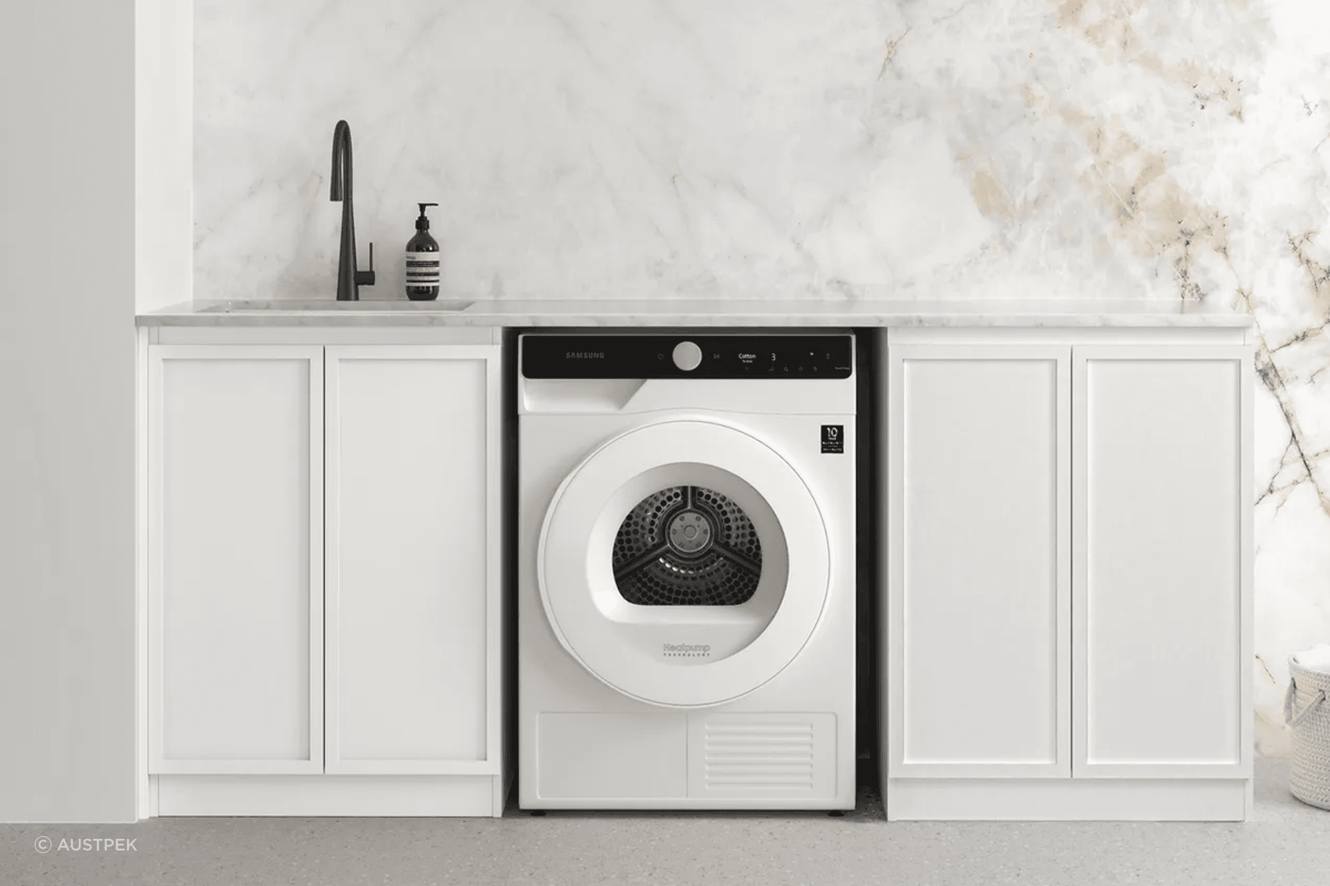 Ample counter space complimented with utility sink for this laundry room