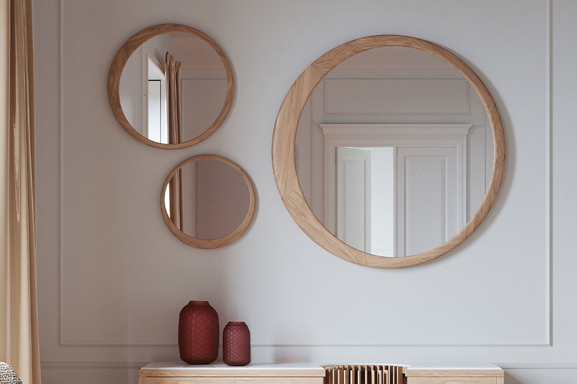 Different sized models of the Luna Round Mirror, gracefully combined together in this wall space.