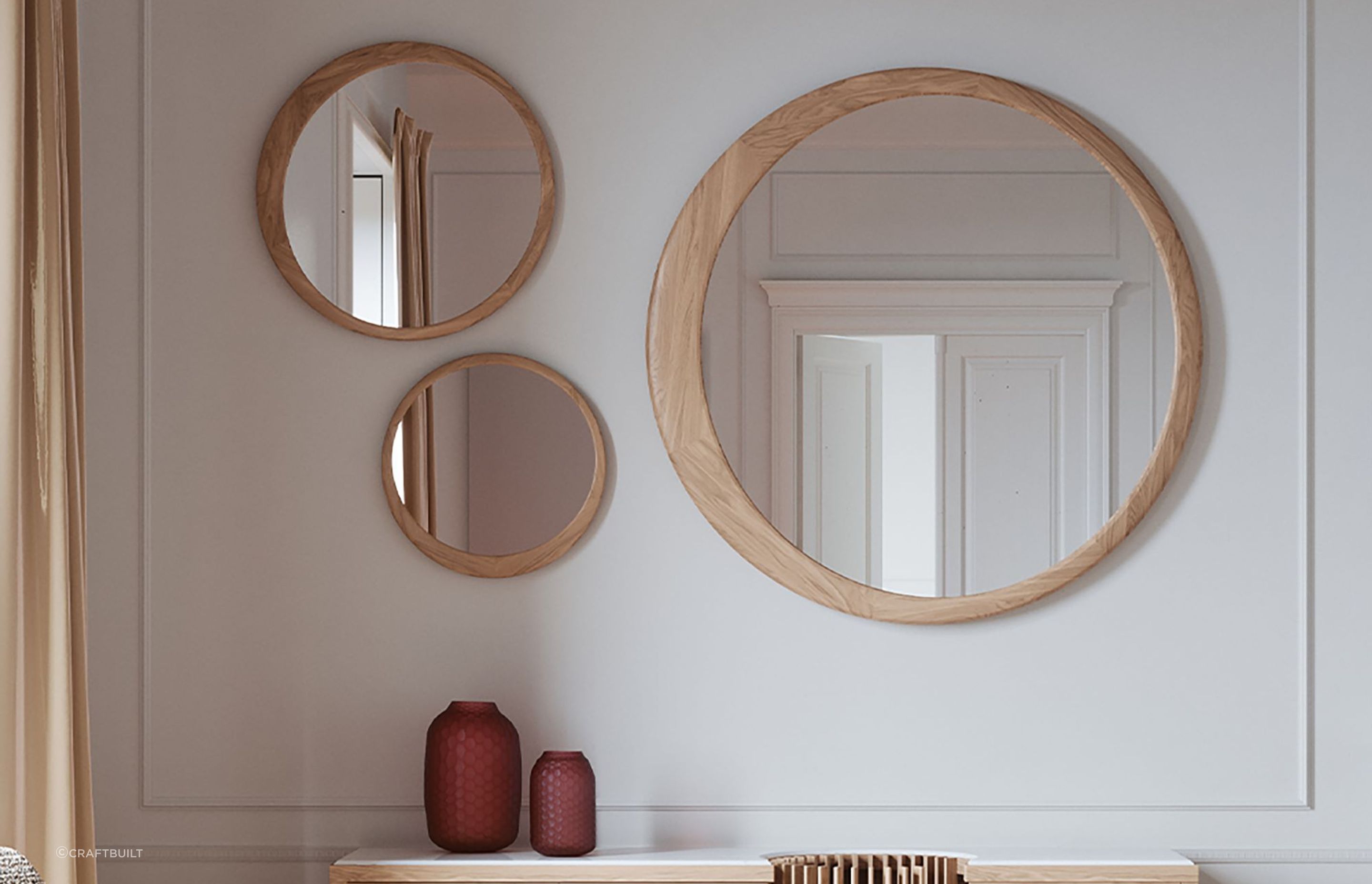 Different sized models of the Luna Round Mirror, gracefully combined together in this wall space.