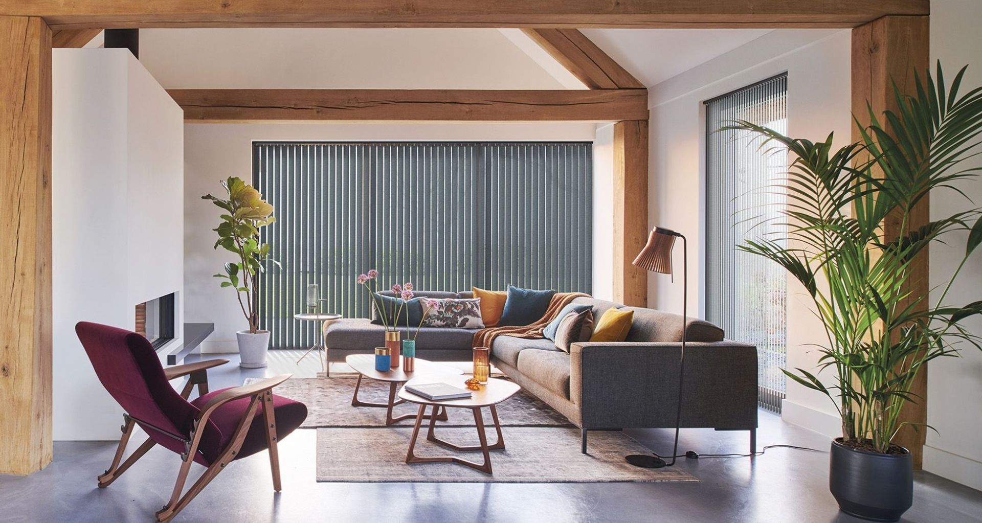 A comfortable and chic space featuring LUXAFLEX® Blockout Vertical Blinds by Guthrie Bowron.