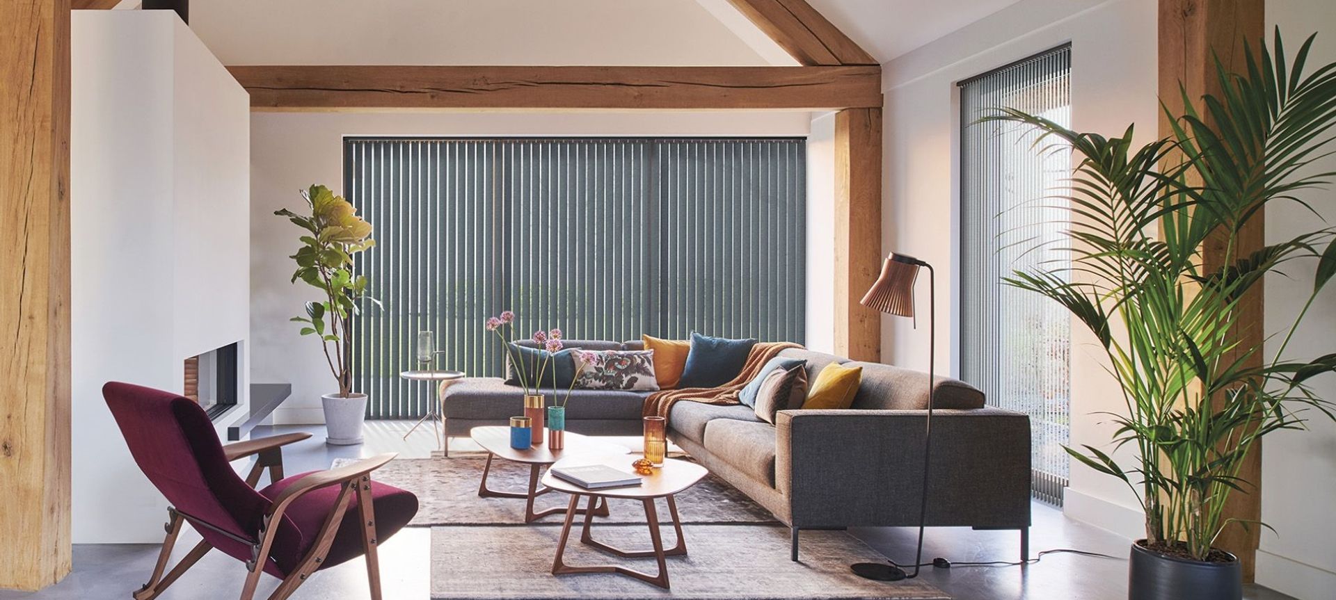 A comfortable and chic space featuring LUXAFLEX® Blockout Vertical Blinds by Guthrie Bowron.