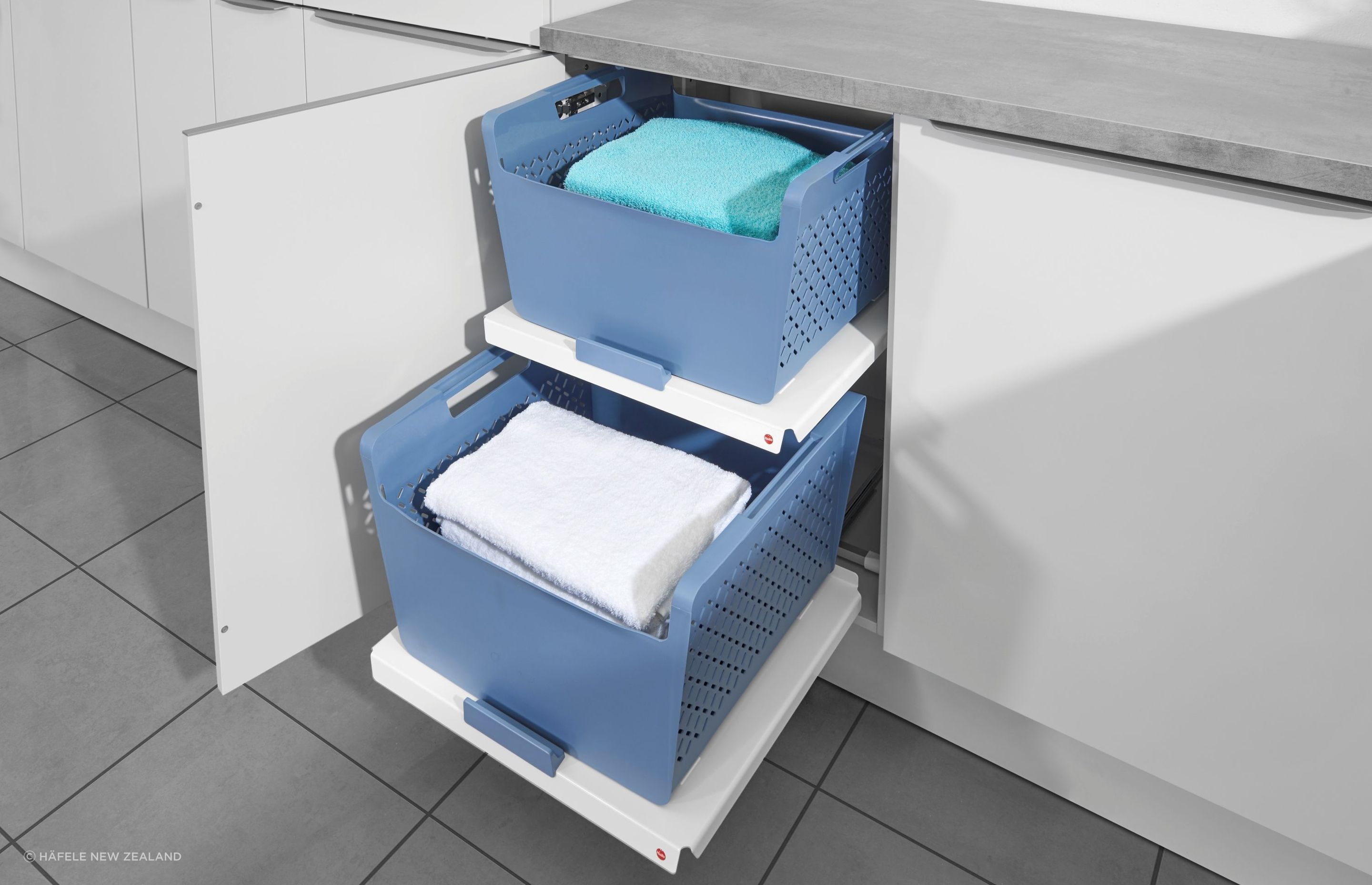 The convenience of the Laundry Pull-Out Shelf + Basket by Häfele New Zealand cannot be understated.