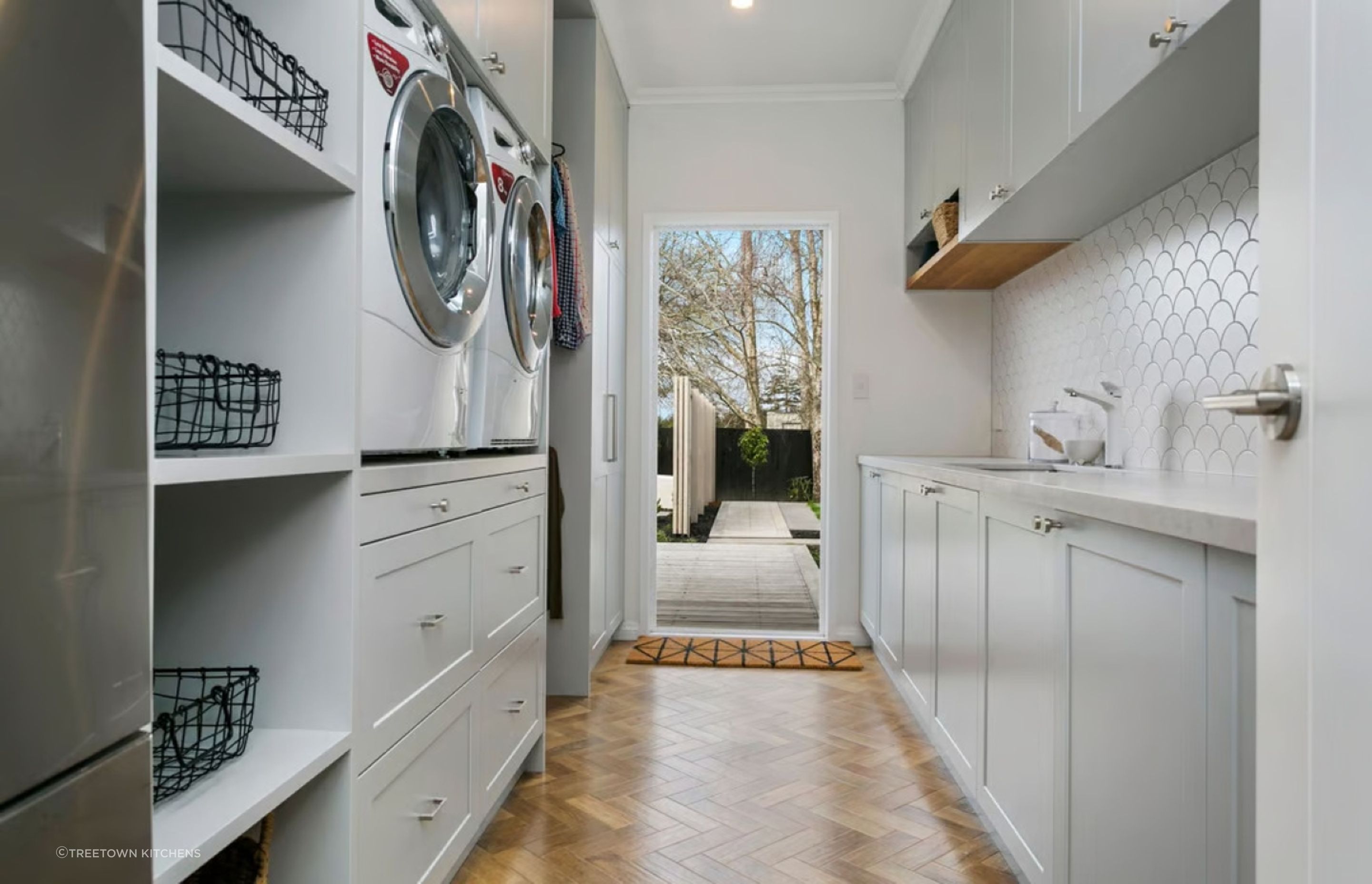 A great example of Herringbone flooring in the laundry space of this renovation project in Tamahere.