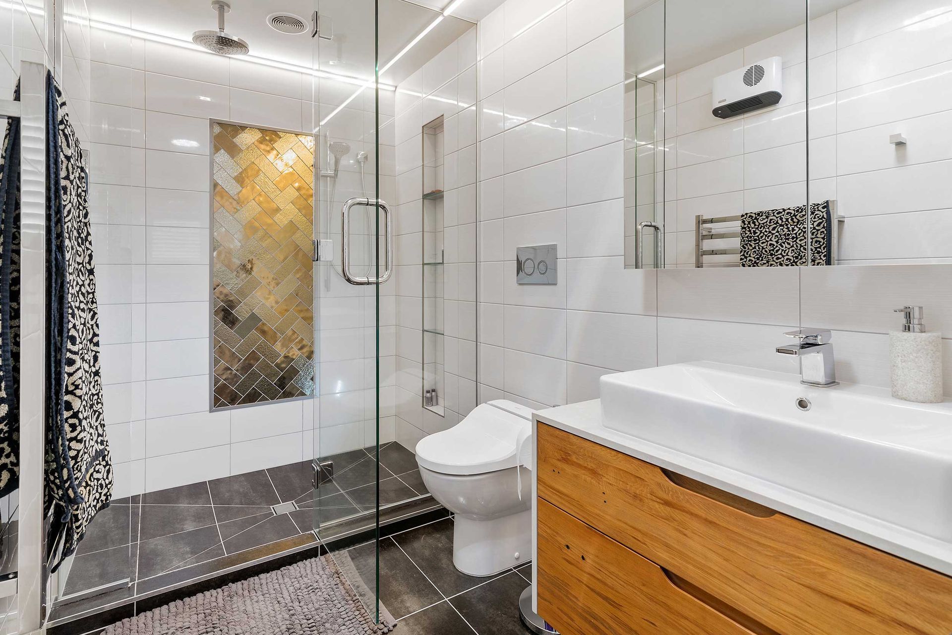 Bronze glass tiles bringing an artistic element to this Lynmore bathroom.