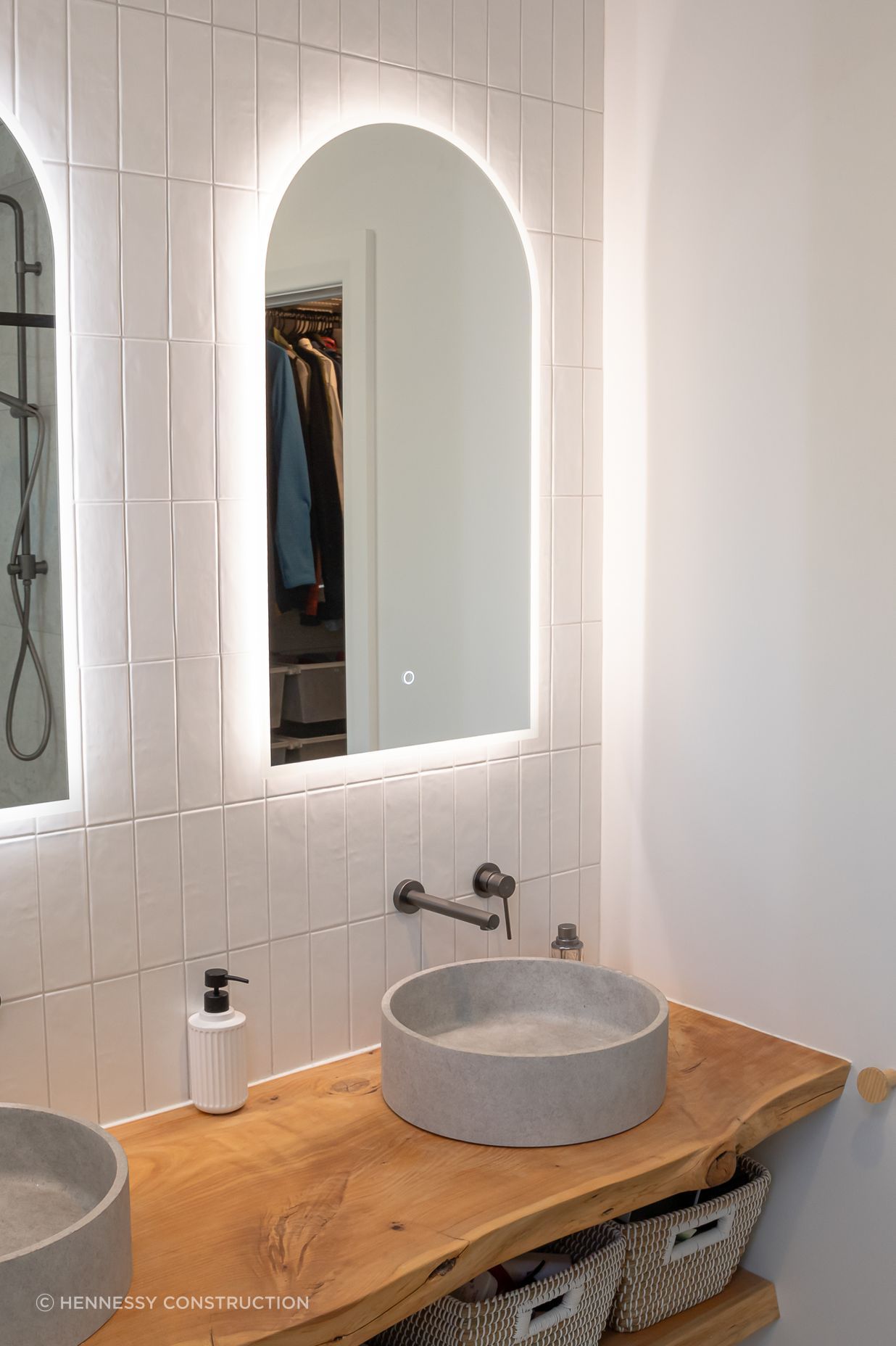 The raw-edge timber vanity ties the new space to the rest of the home.