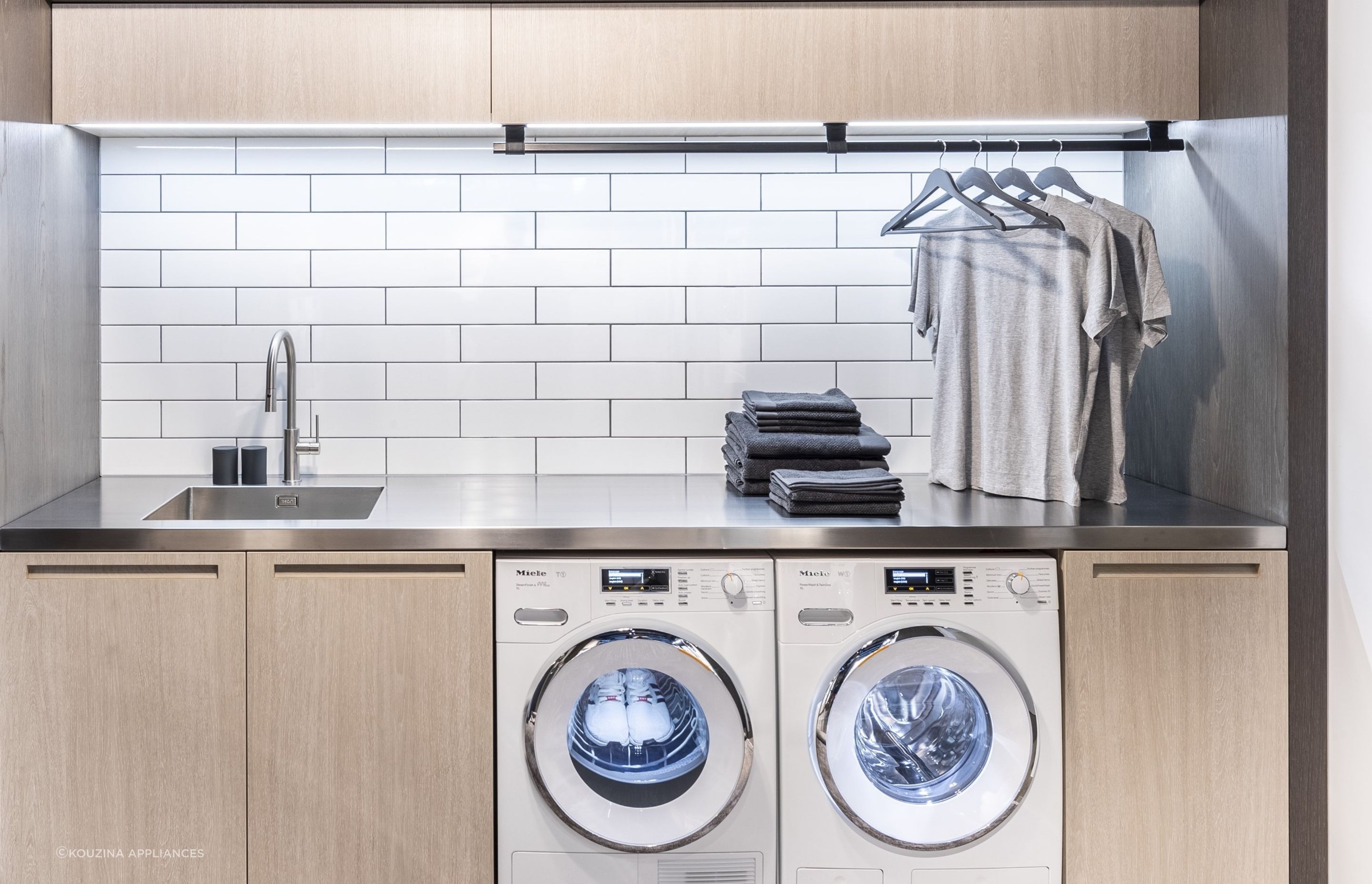 Classic subway tiles are a popular choice for a laundry splashback, seen here in a laundry featuring the equally popular 9KG Condenser Dryer with Heat Pump Technology by Miele.
