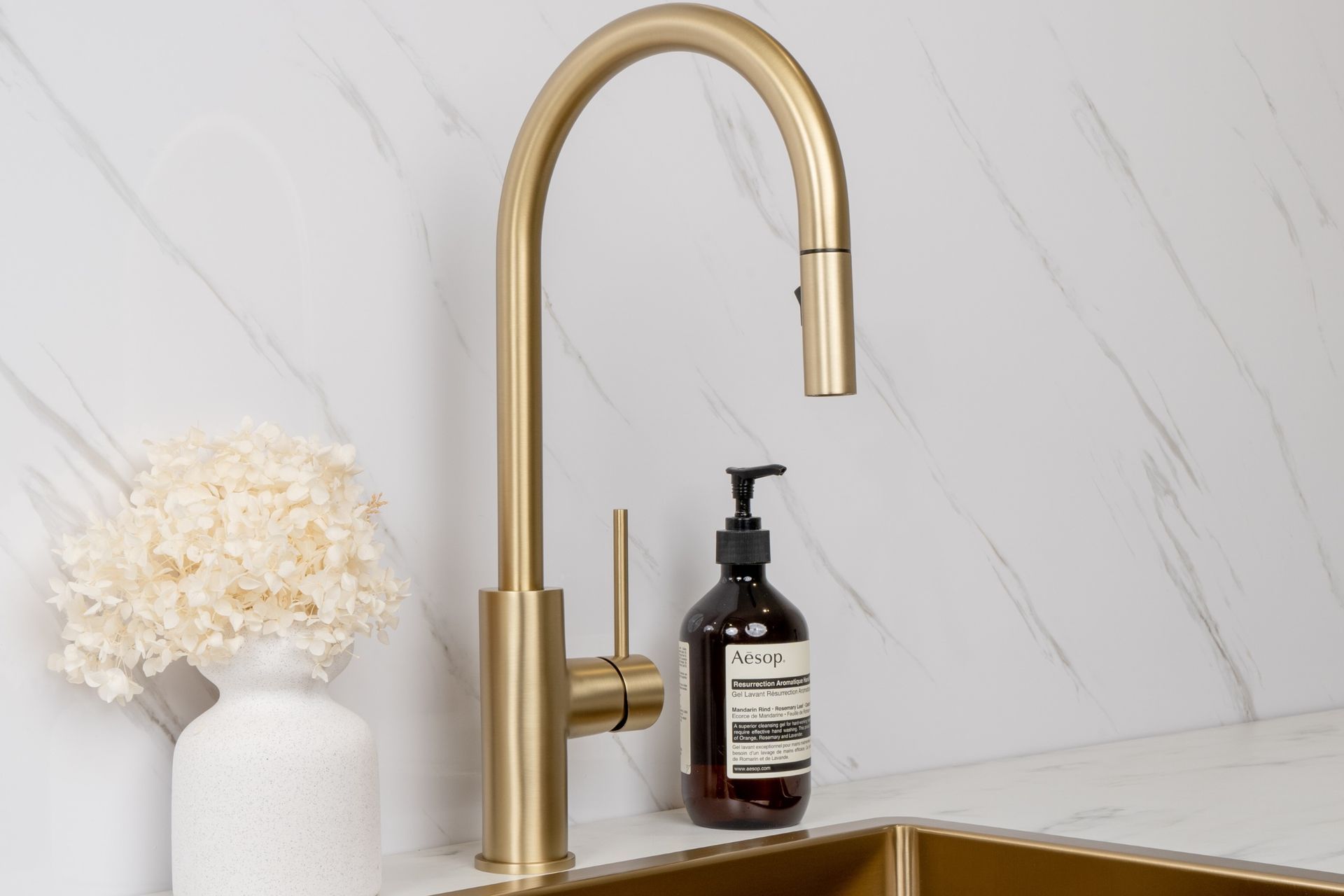 The sleek satin-matte surface of the Mira Brushed Brass Gold Pull Out Mixer makes it an instant focal point.