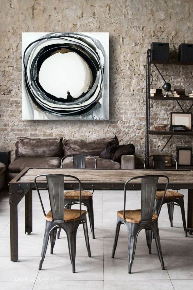 The wall art in this living space reflects the Industrial interior design style.