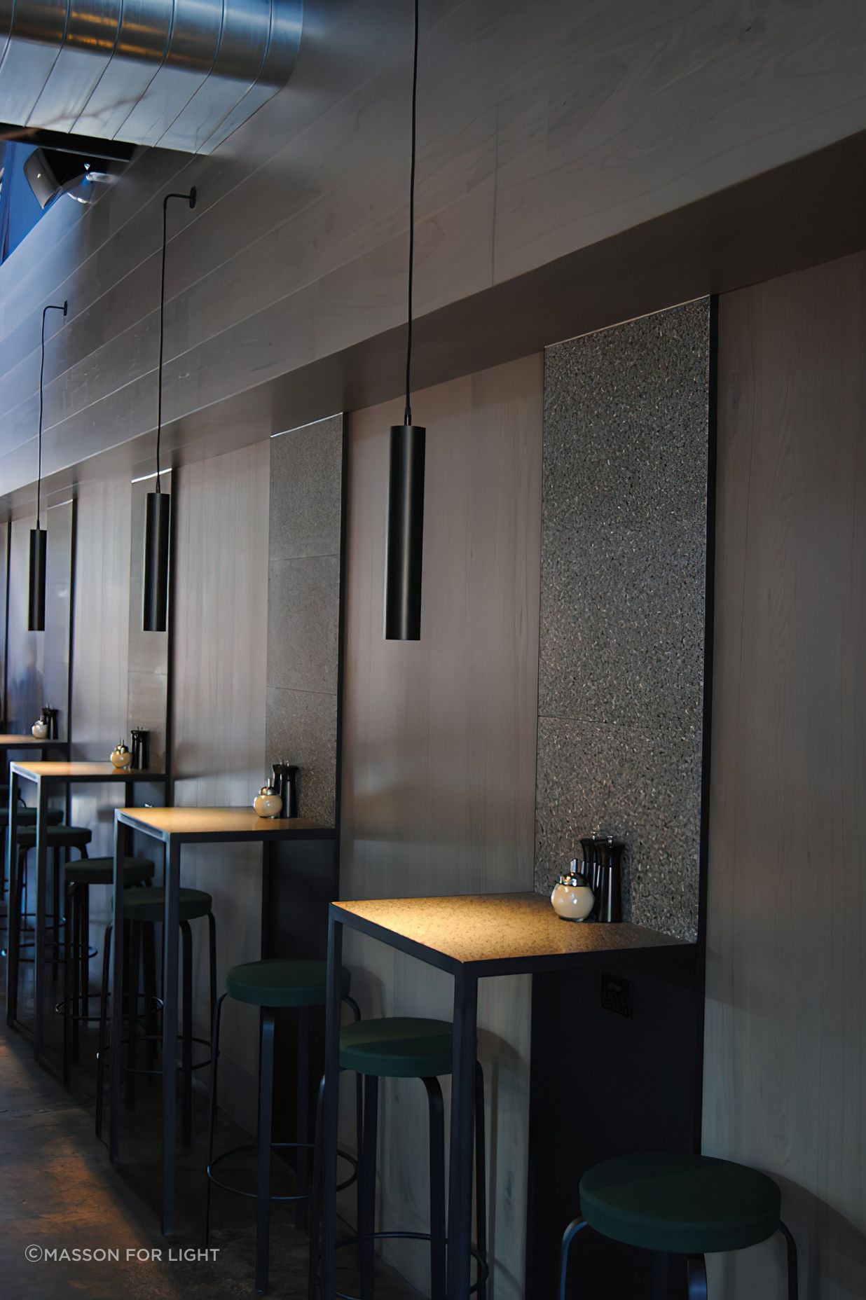 A single pendant sets the mood for each table.