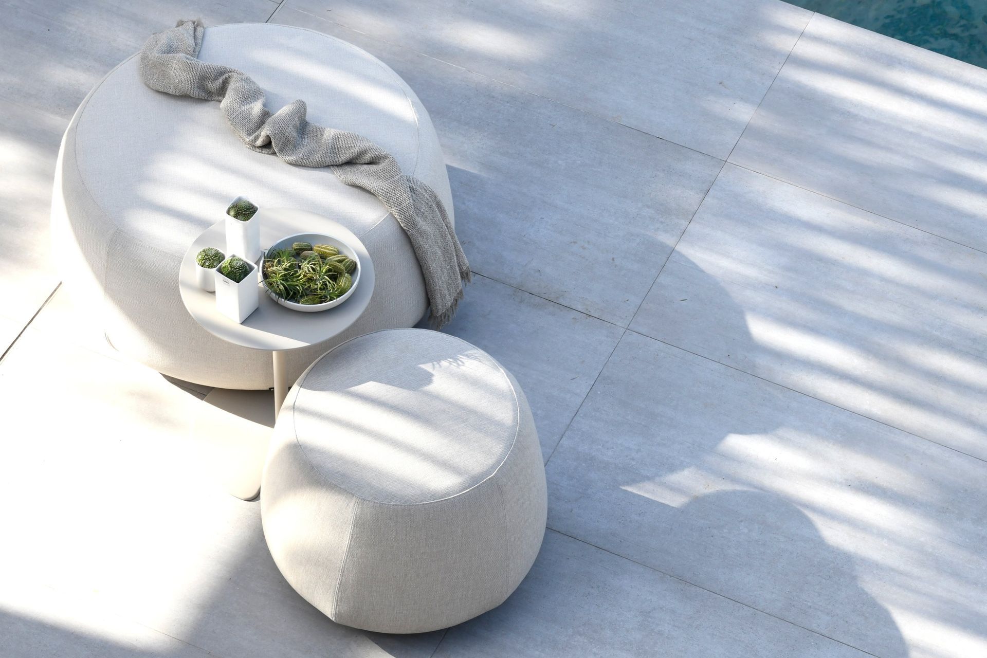 The Nomad Pouf by Dawson &amp; Co. is a versatile outdoor furnishing that can be used in many different ways.