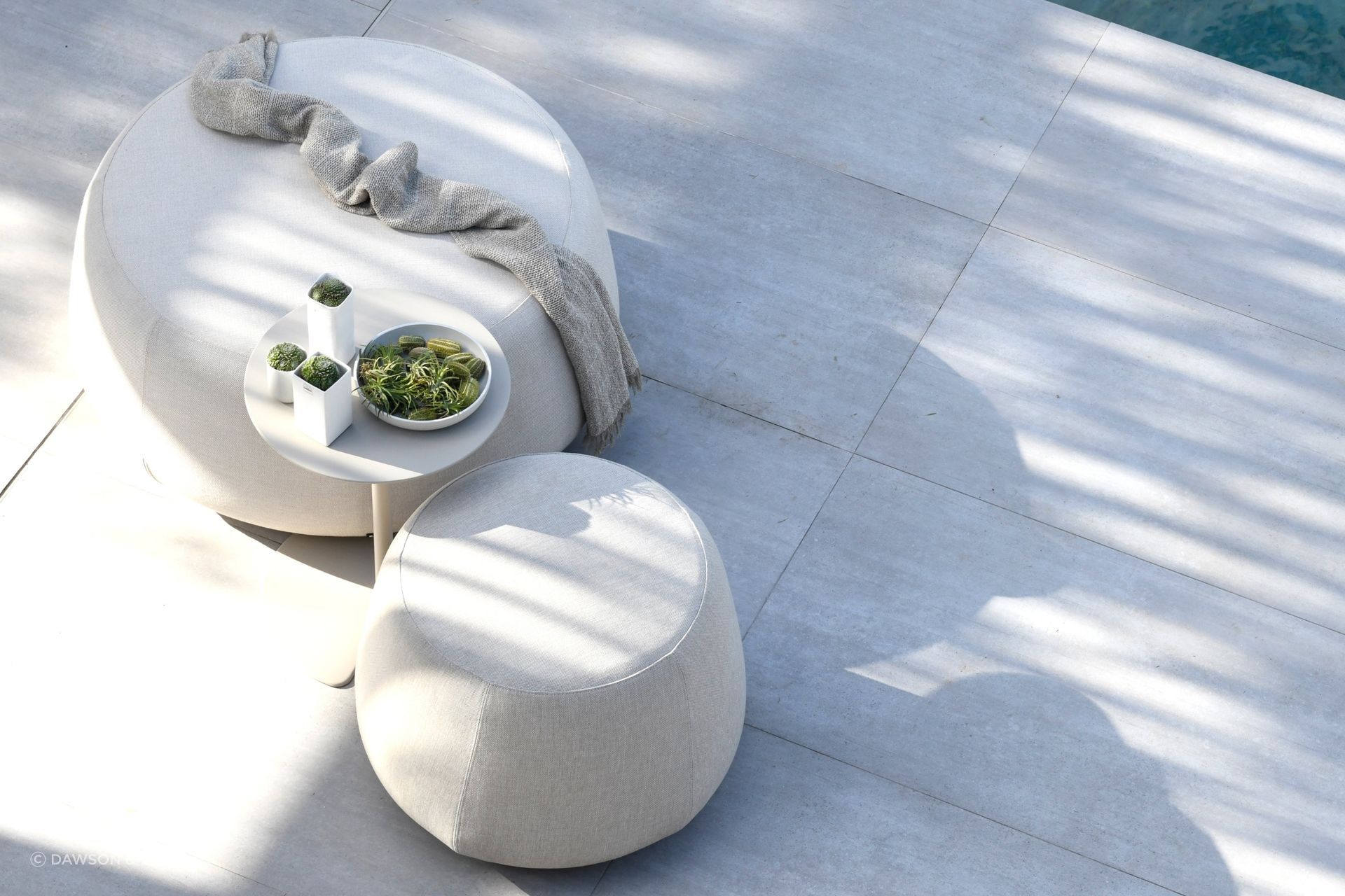 The Nomad Pouf by Dawson &amp; Co. is a versatile outdoor furnishing that can be used in many different ways.