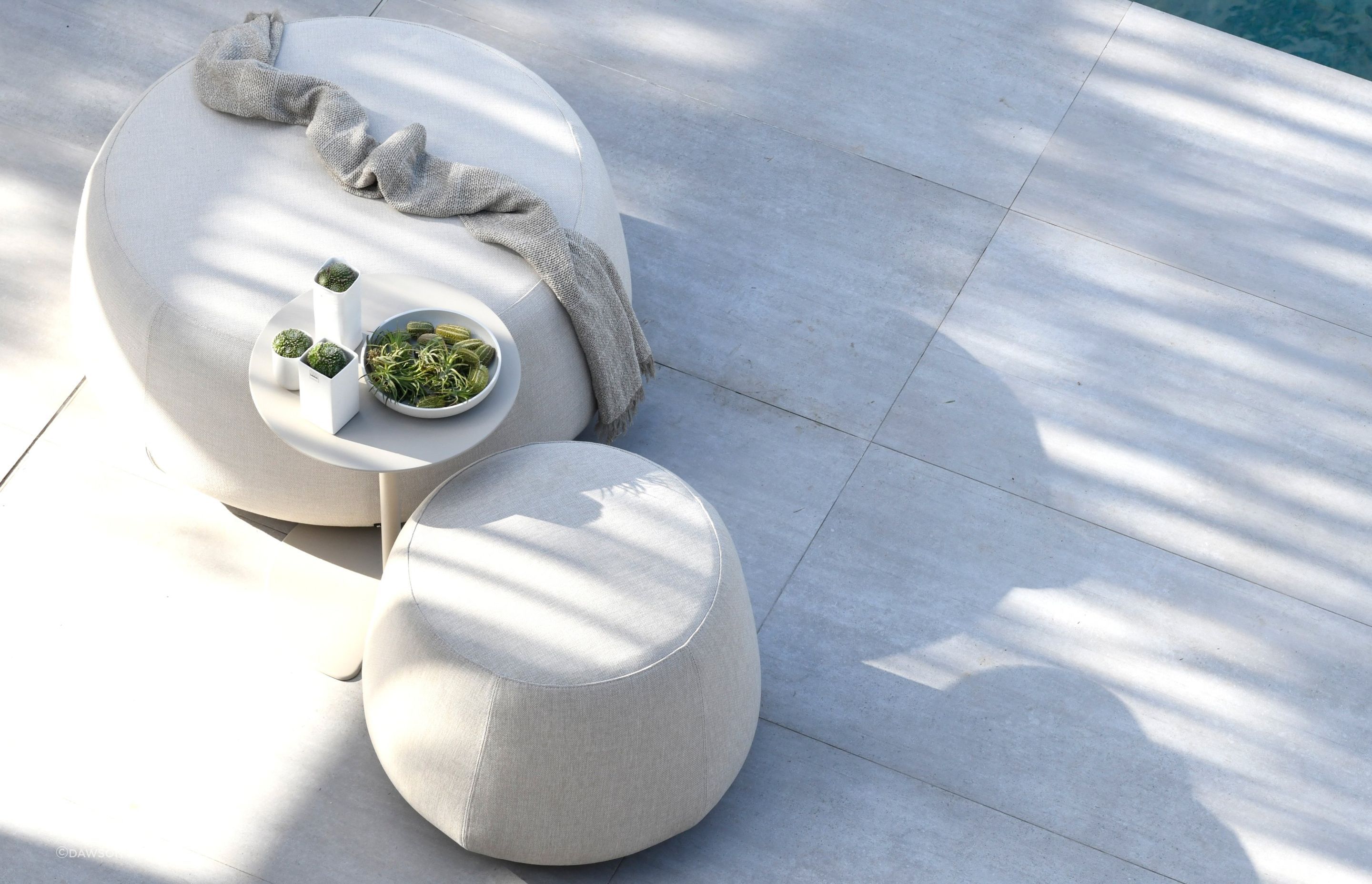The Nomad Pouf by Dawson & Co. is a versatile outdoor furnishing that can be used in many different ways.
