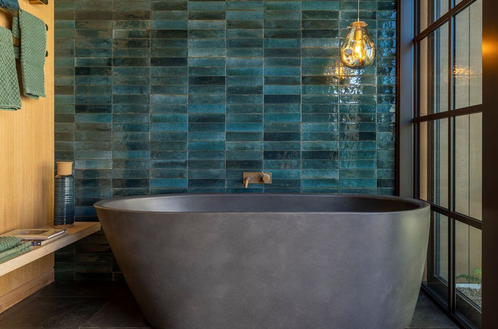 This beautiful bathroom in a Waiheke Island home has a colour schemed inspired by the local kingfishers — Photography: Bridget Hackshaw