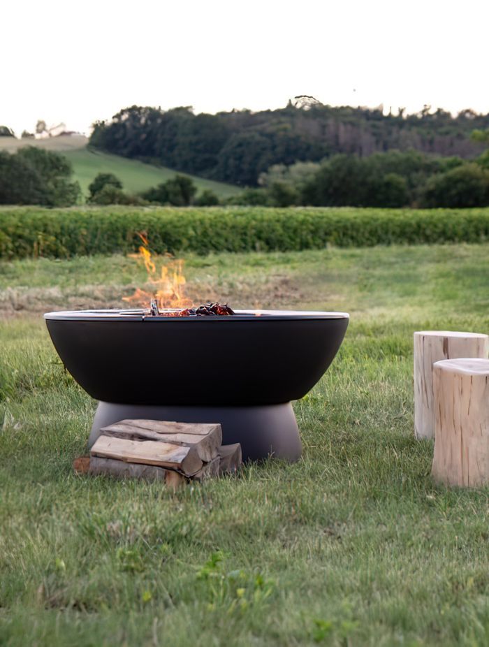 Outdoor fire pits add a rugged, rustic appeal to an outdoor area. Featured product: Hergom Meteor Cast Iron Fire Pit.