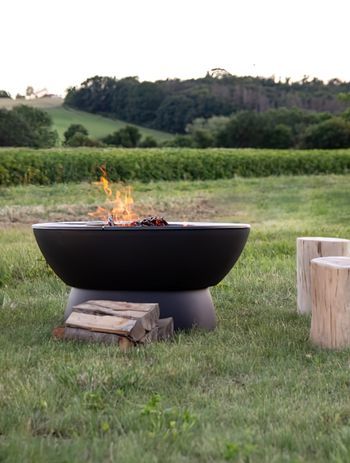Outdoor fire pits add a rugged, rustic appeal to an outdoor area. Featured product: Hergom Meteor Cast Iron Fire Pit.