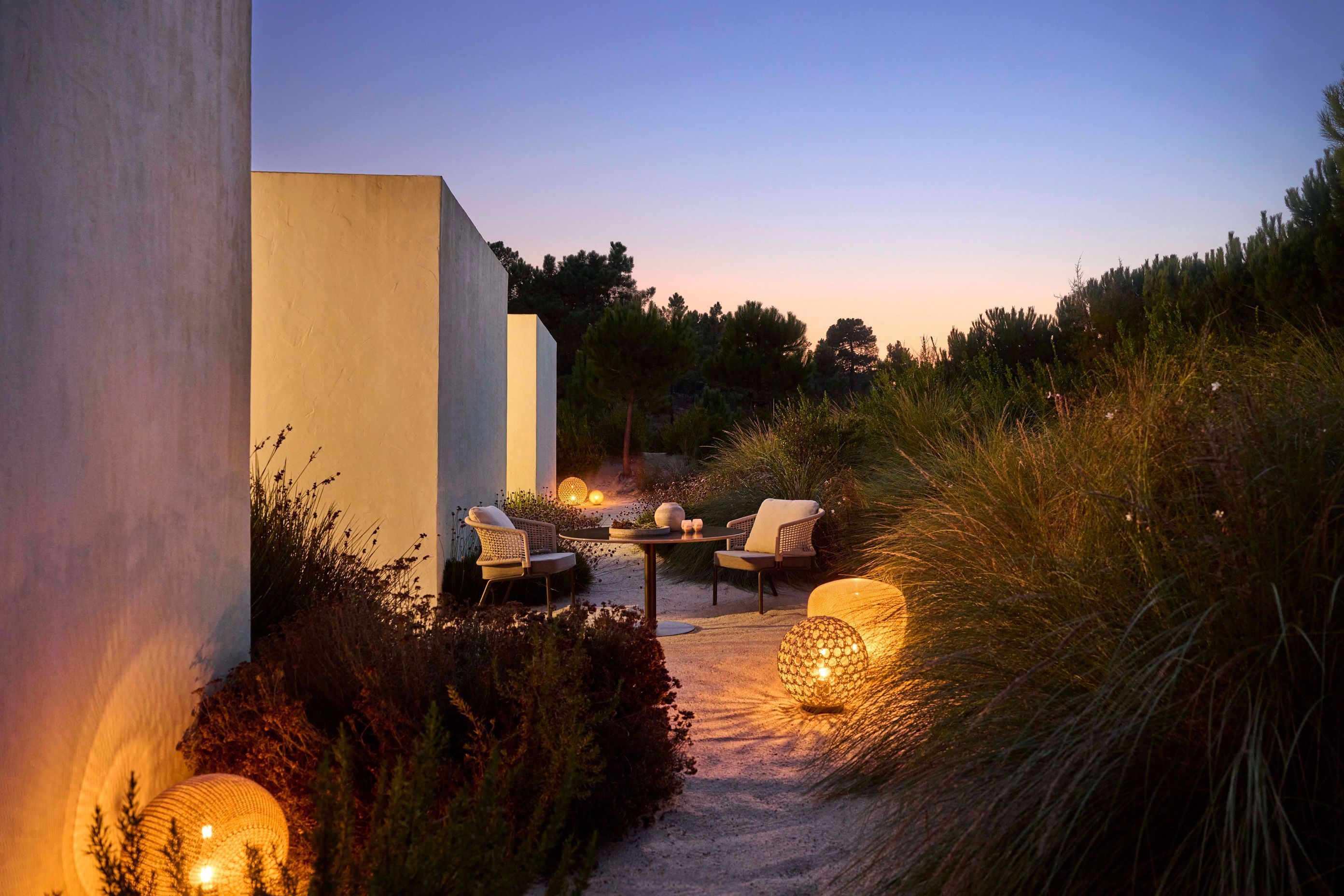 Integrate the Monsieur Tricot lighting with textural outdoor furniture for a seamless indoor/outdoor experience.